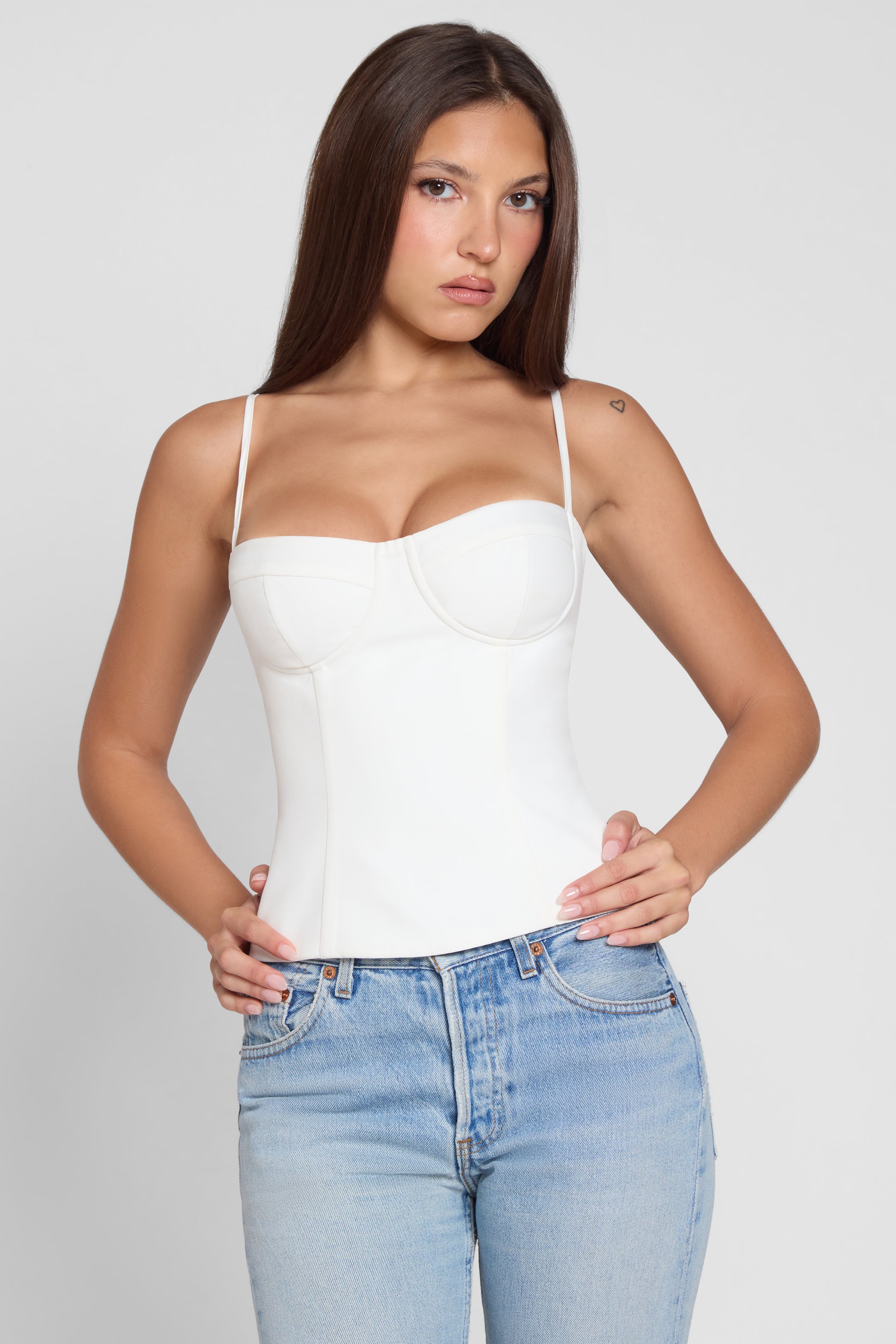 Model is wearing Bali Bustier Corset Top White, front view.