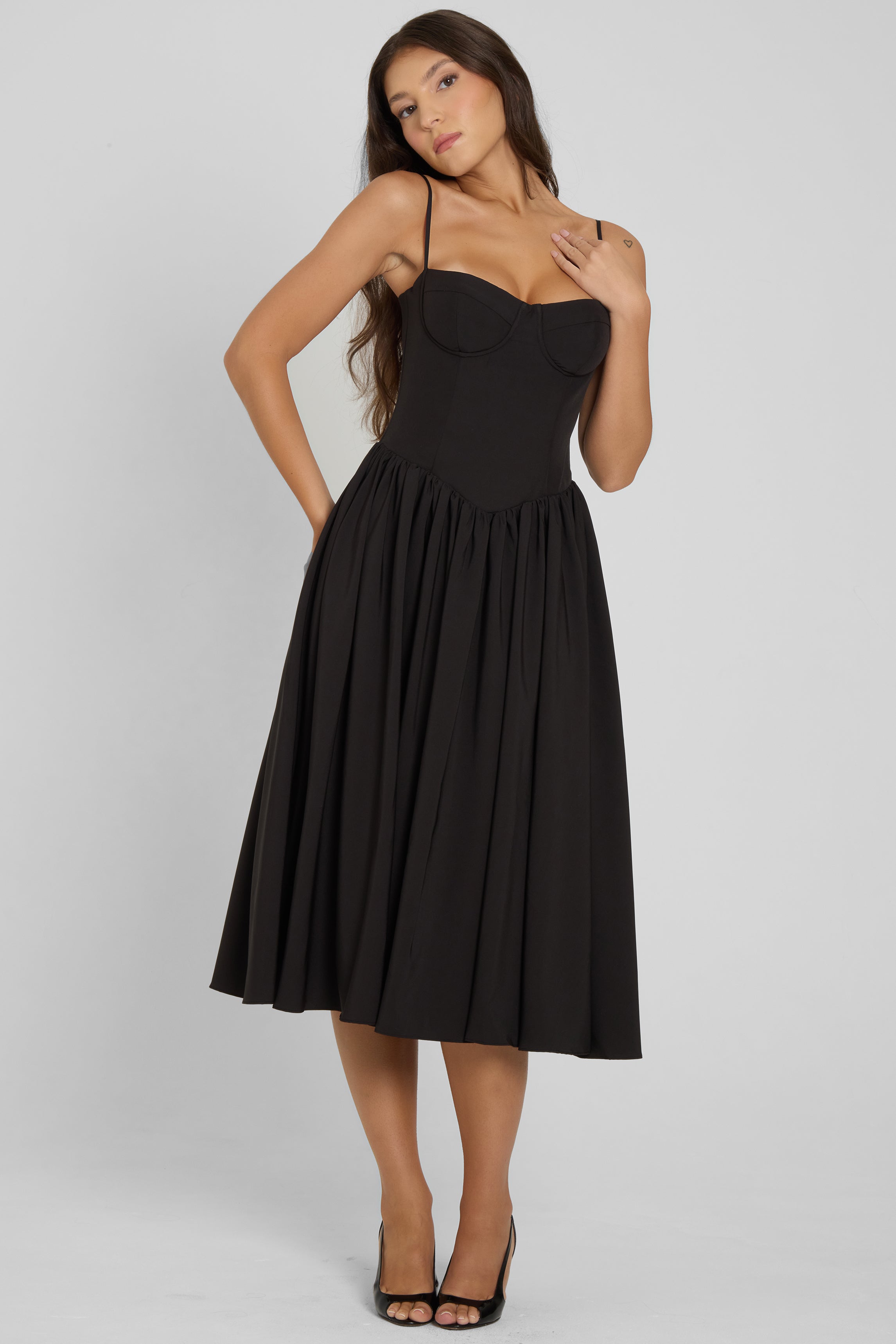 Model wearing Ballerina Bustier Midi Dress in Black, front view.
