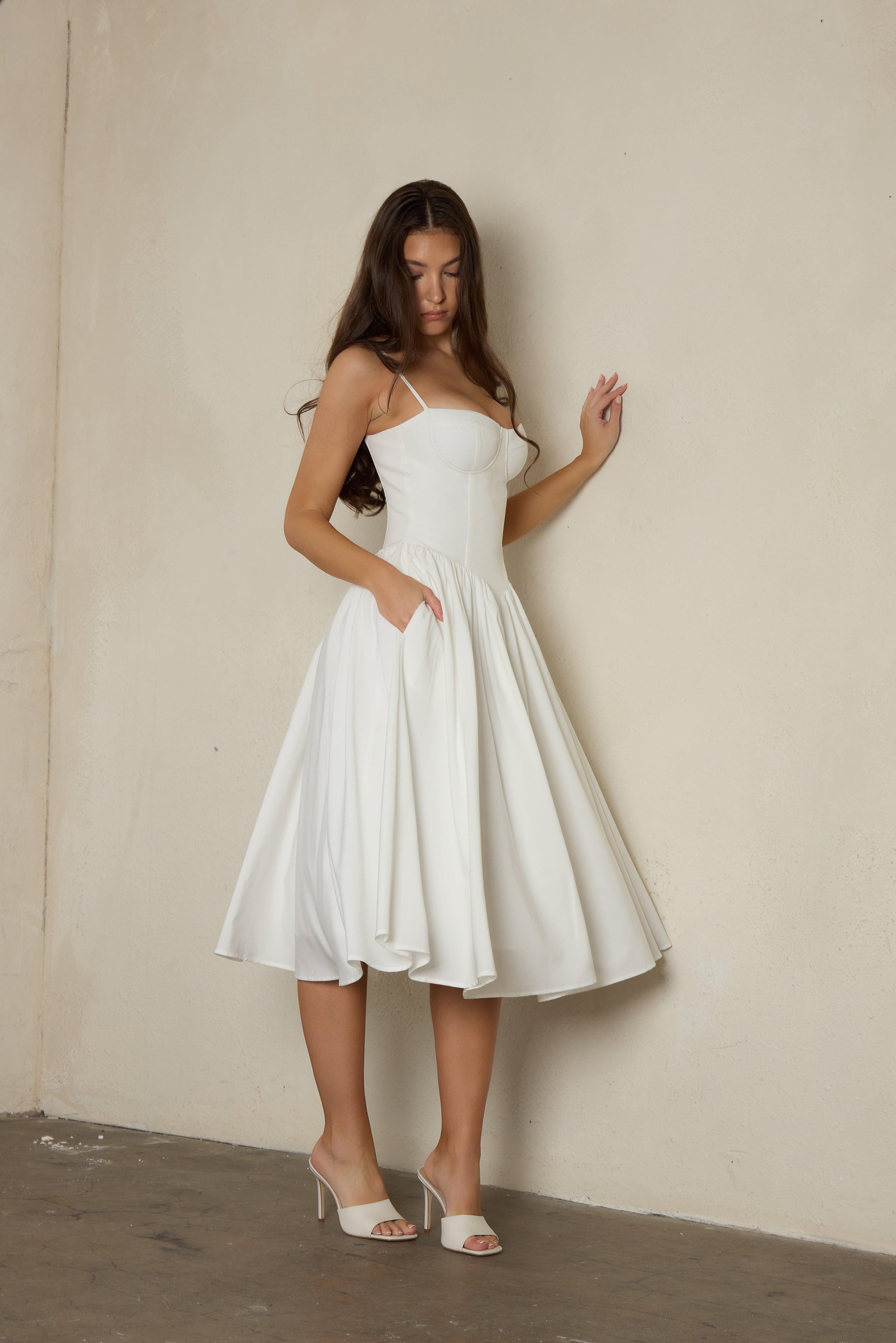 Model wearing Ballerina Bustier Midi Dress in White, side view.