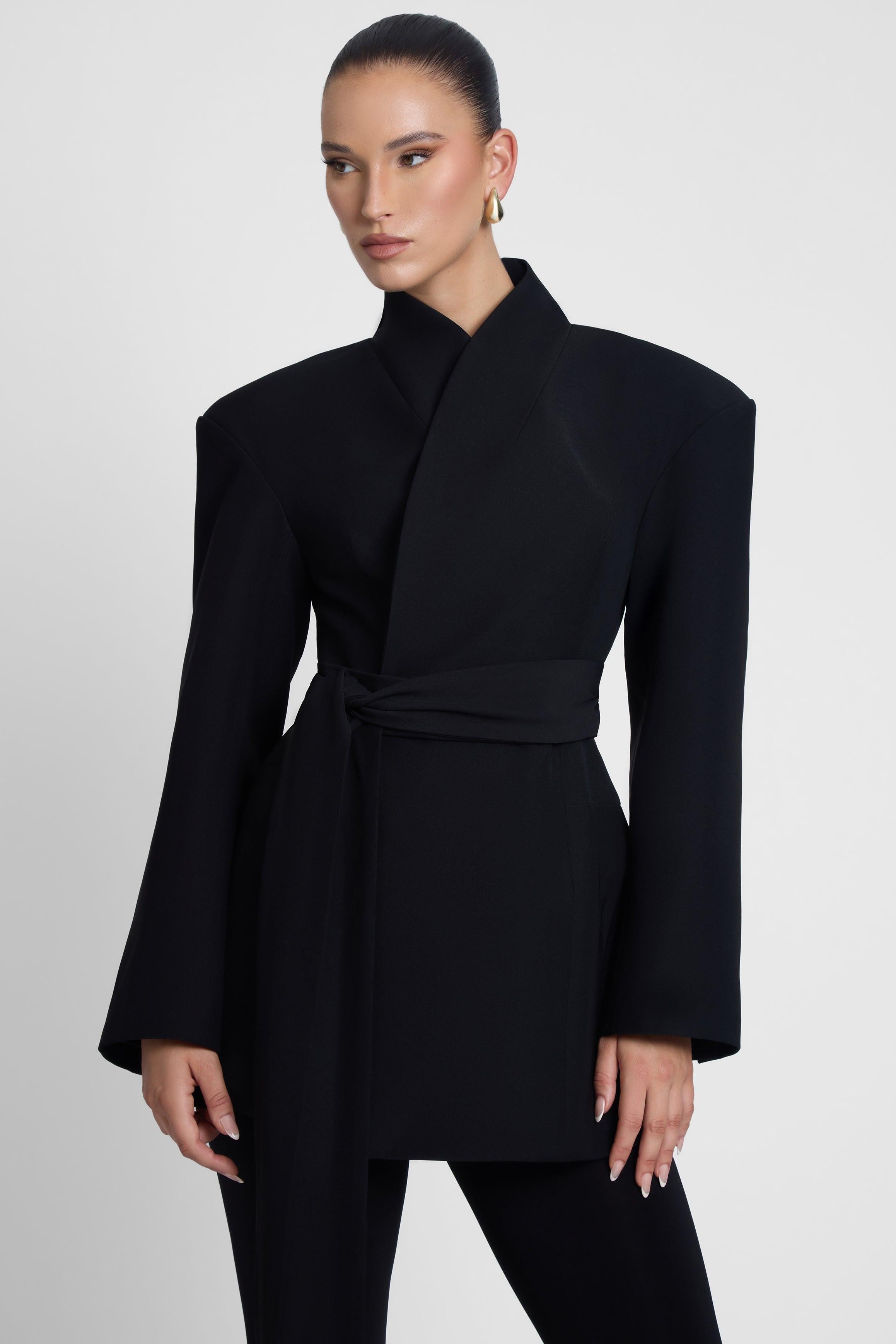 Model is wearing Cairo Hourglass Belted Coat Black, front view.
