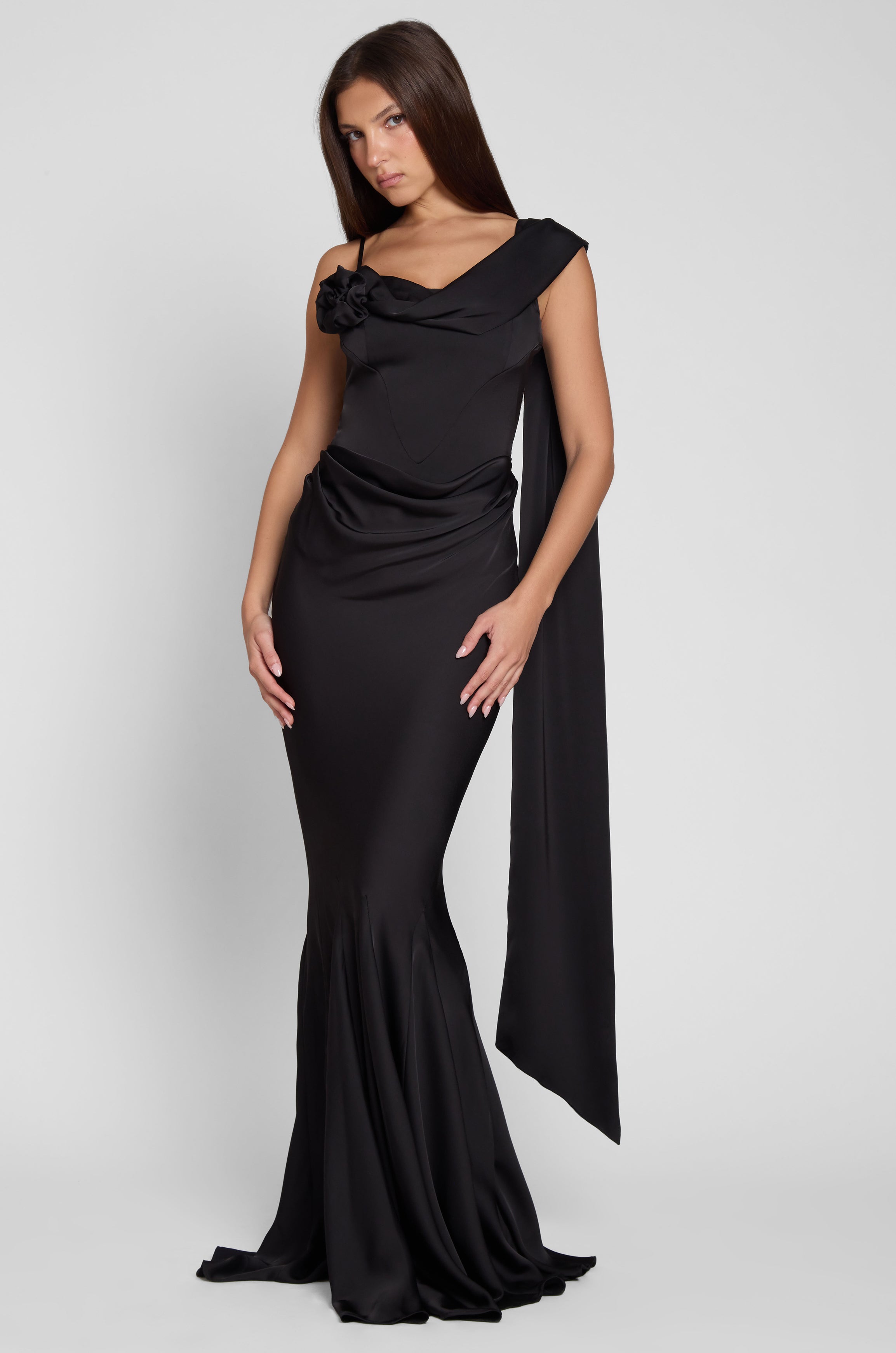 Model is wearing Celine Corset Drape Satin Gown in Black, front view.