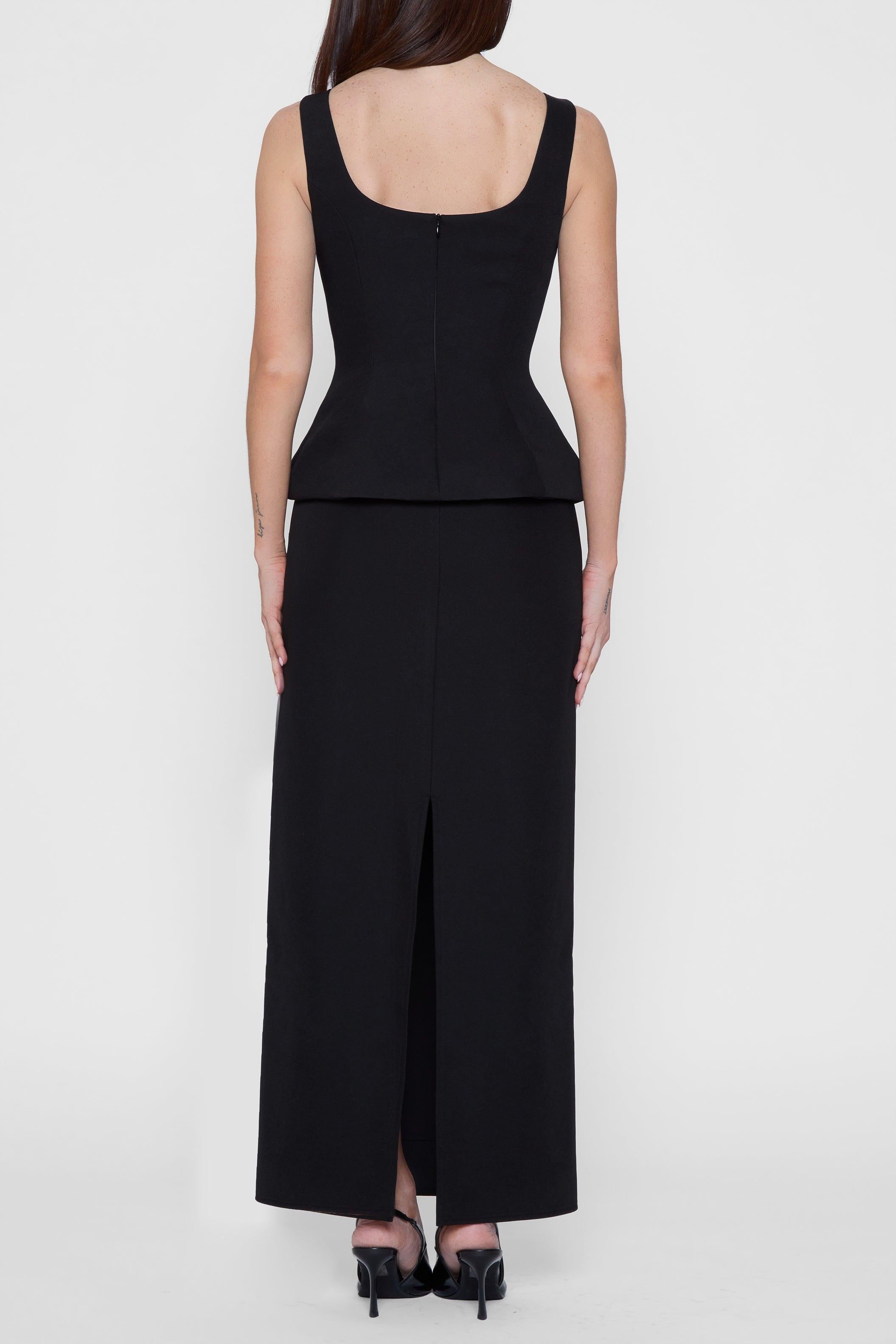 Model wearing Classic Column Maxi Skirt in Black, back view.