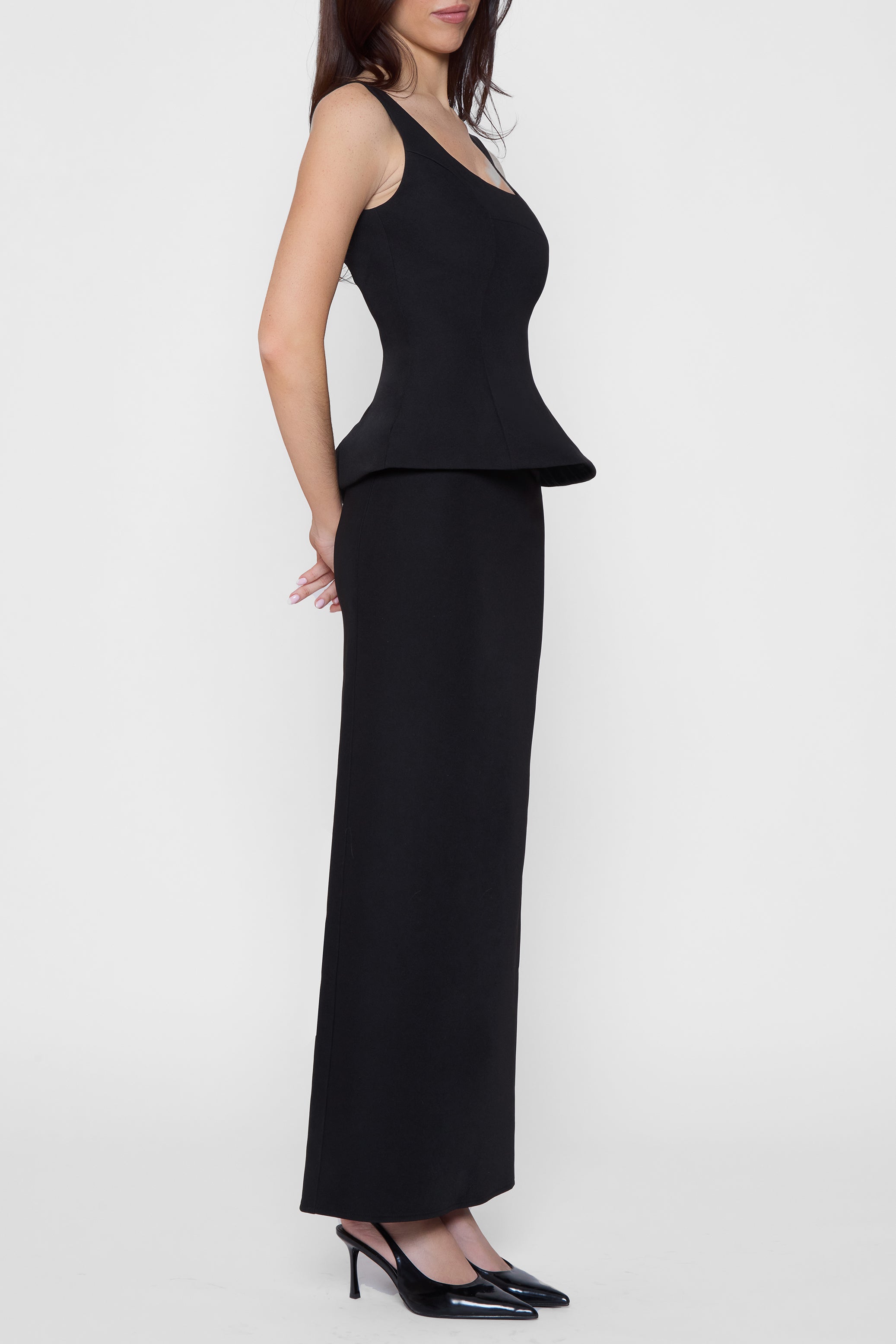 Model wearing Classic Column Maxi Skirt in Black, side view.