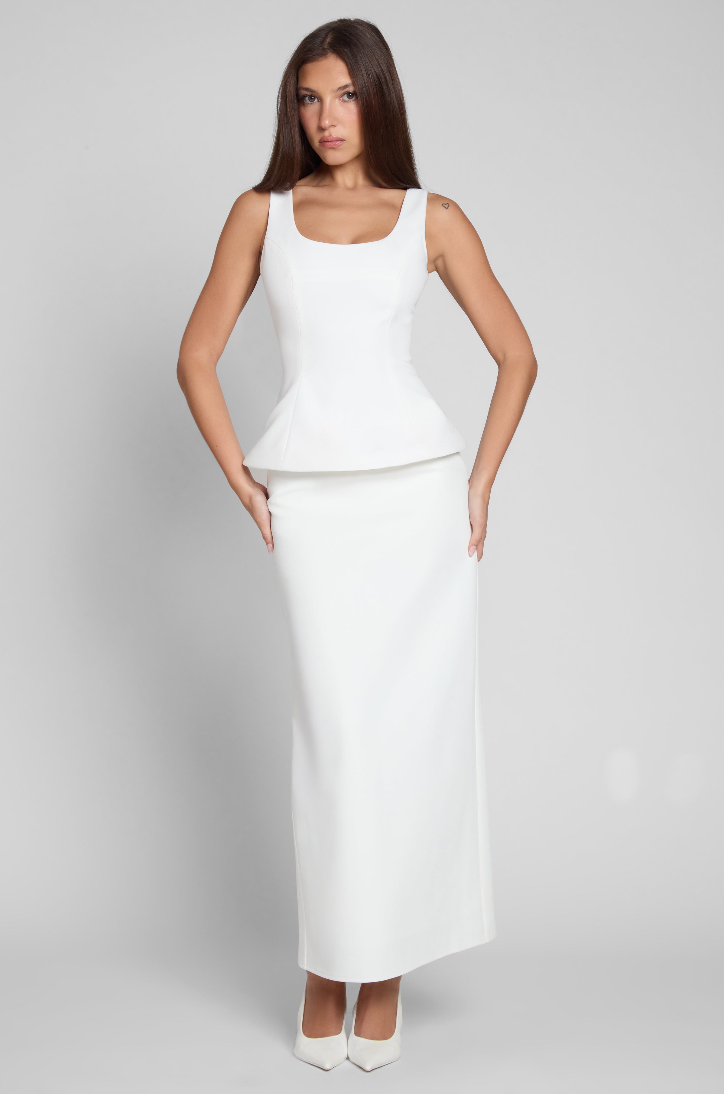 Model is wearing Classic Column Maxi Skirt in White, front view.