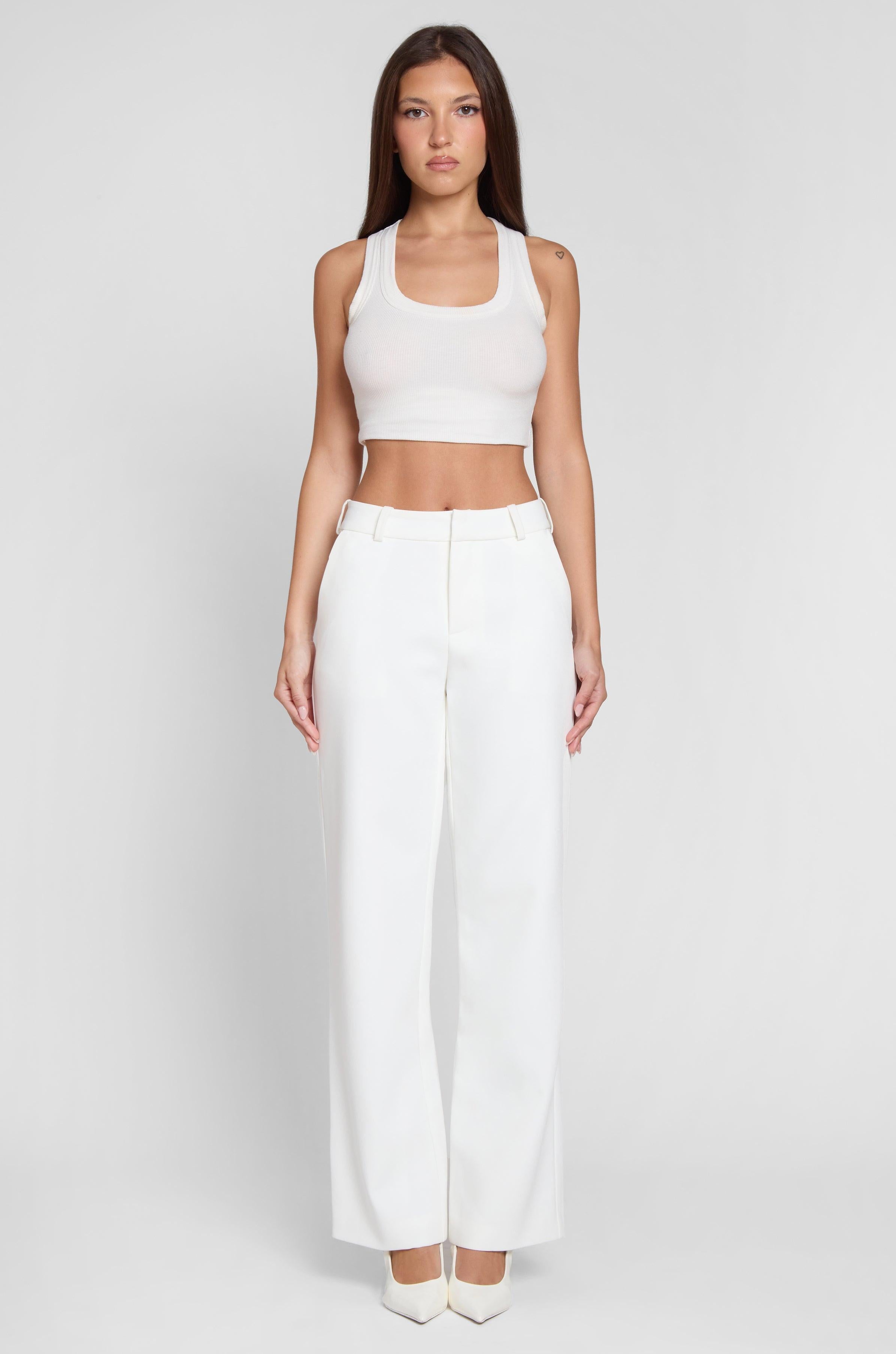 Model wearing Classic Column Straight Trousers in White, front view.