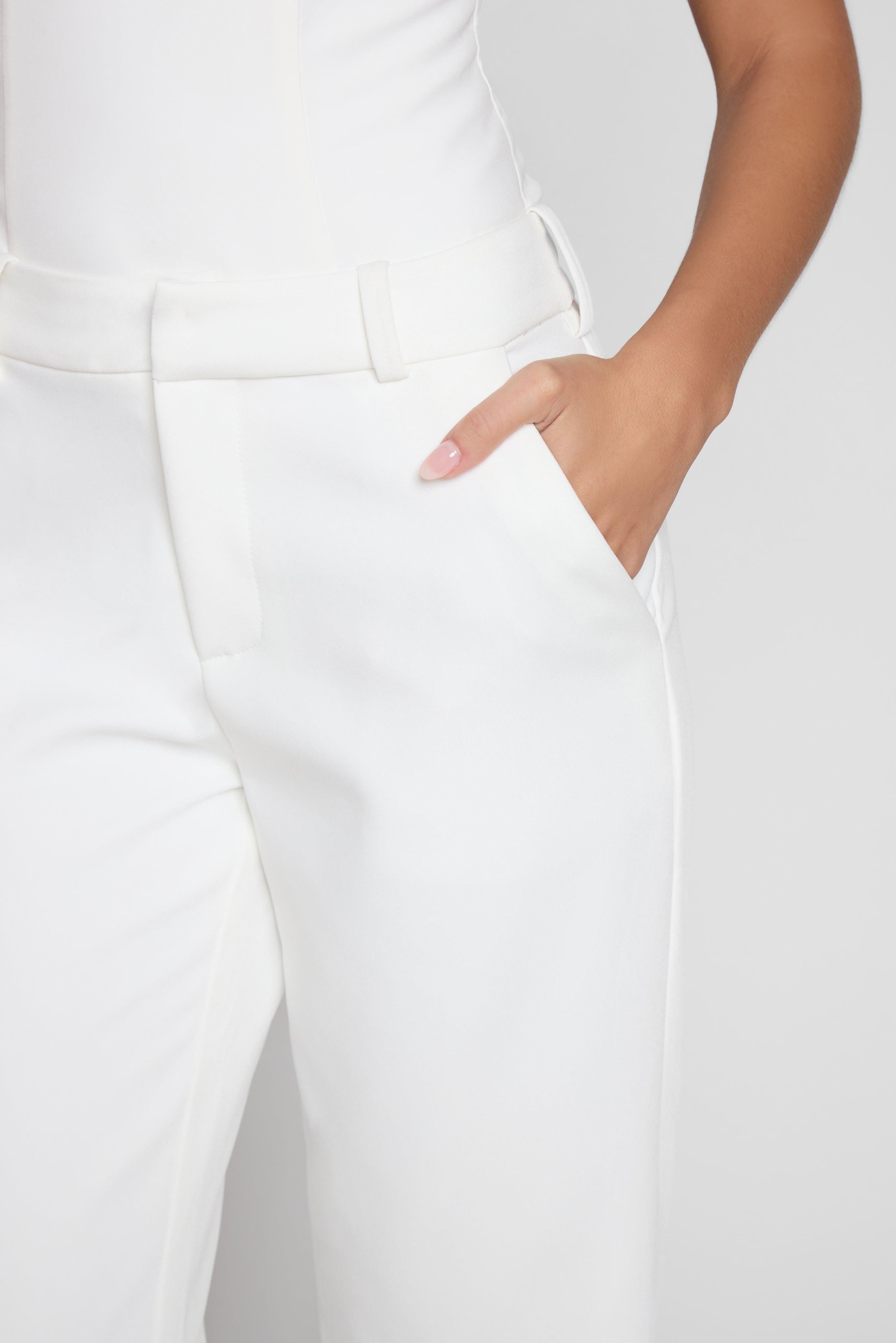 Model wearing Classic Column Straight Trousers in White, front view.