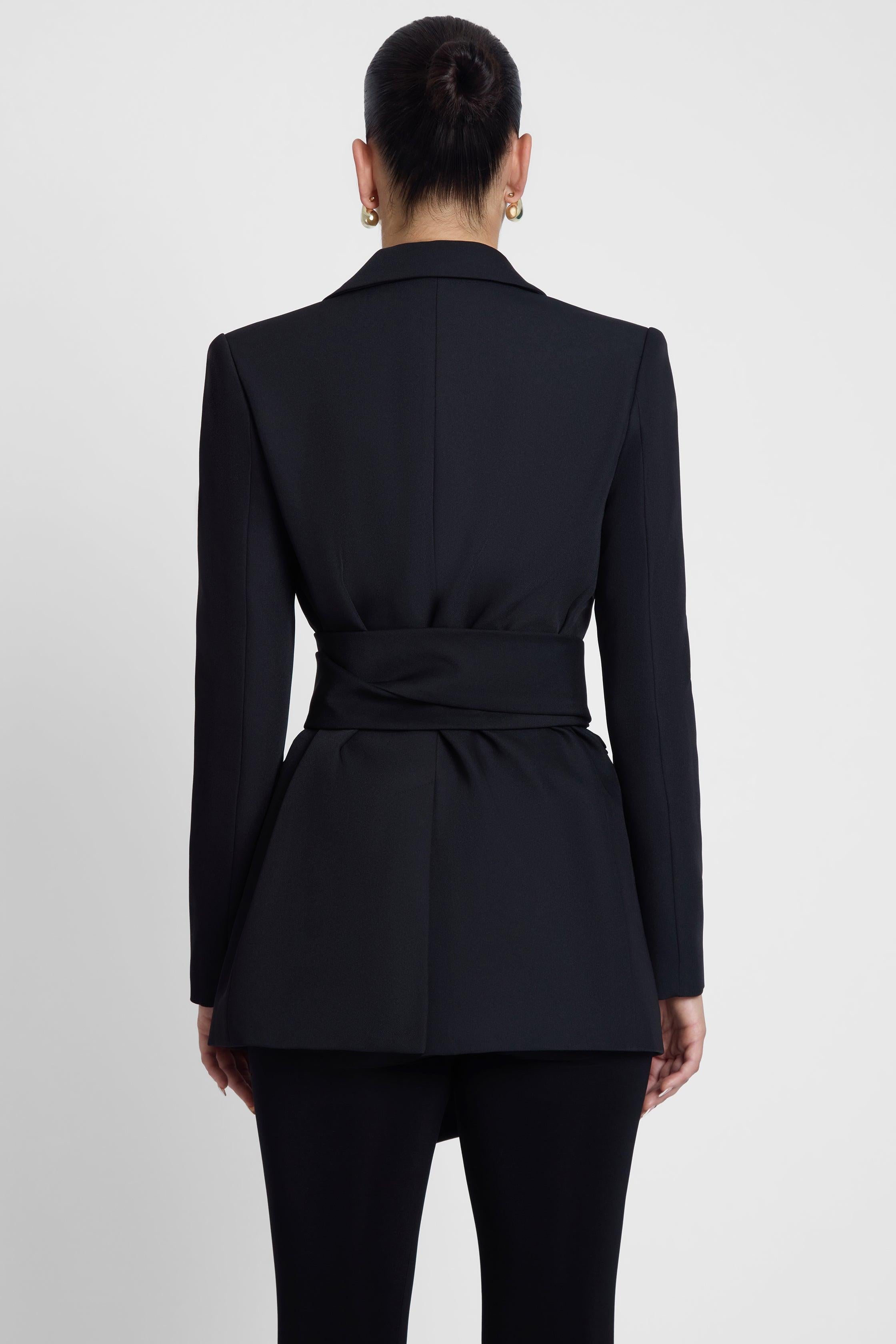 Model is wearing Classic Column Tailored Belted Blazer Black, back view.