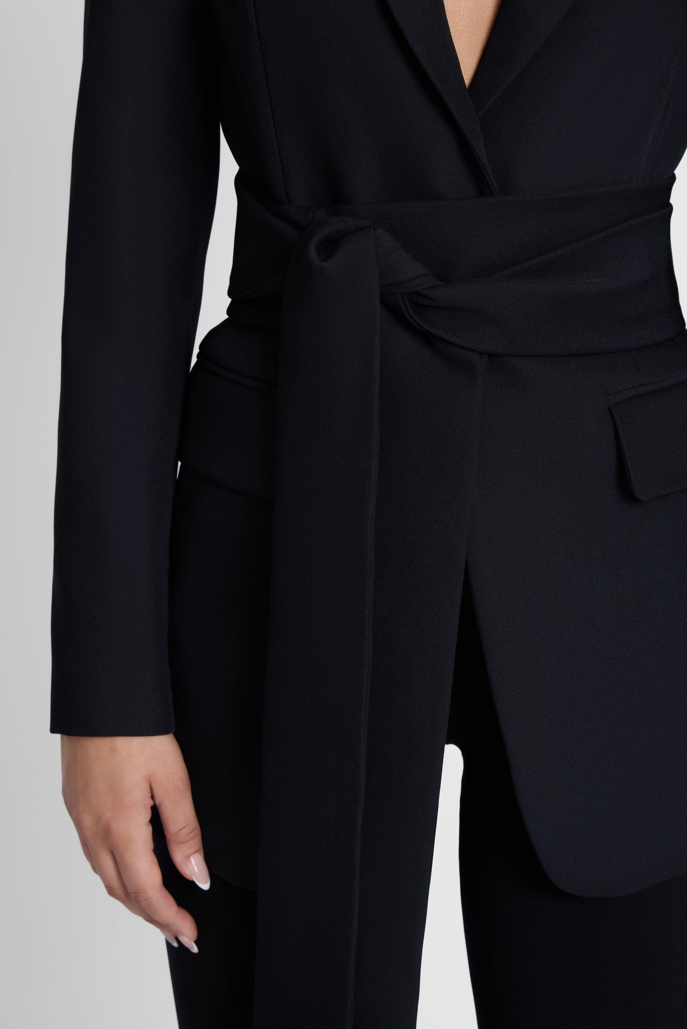 Model is wearing Classic Column Tailored Belted Blazer Black, front view.