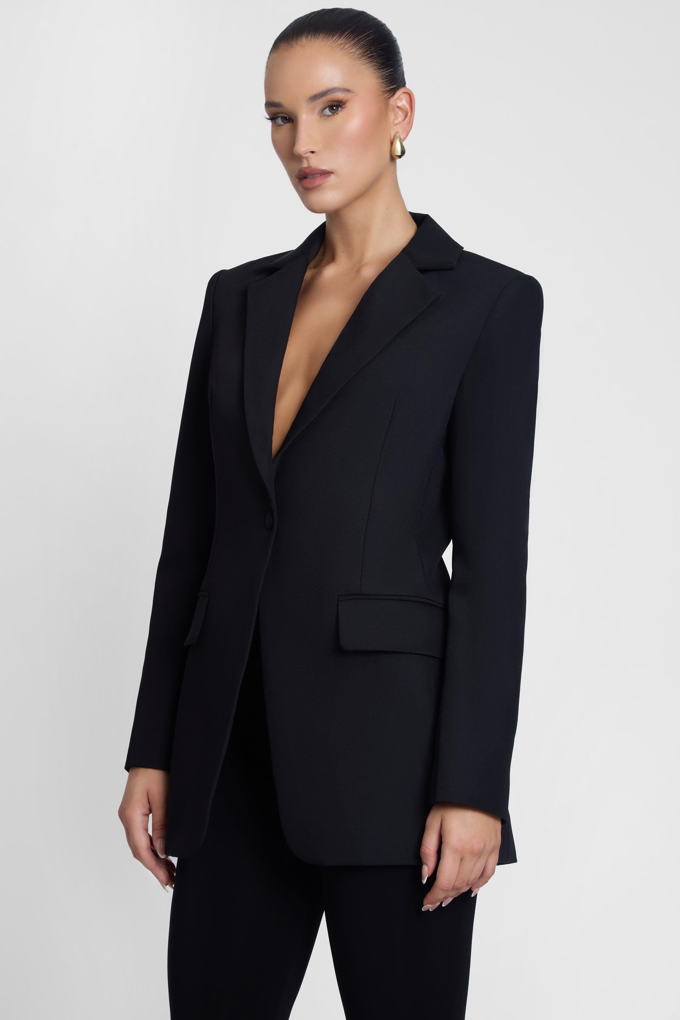 Model is wearing Classic Column Tailored Belted Blazer Black, side view.