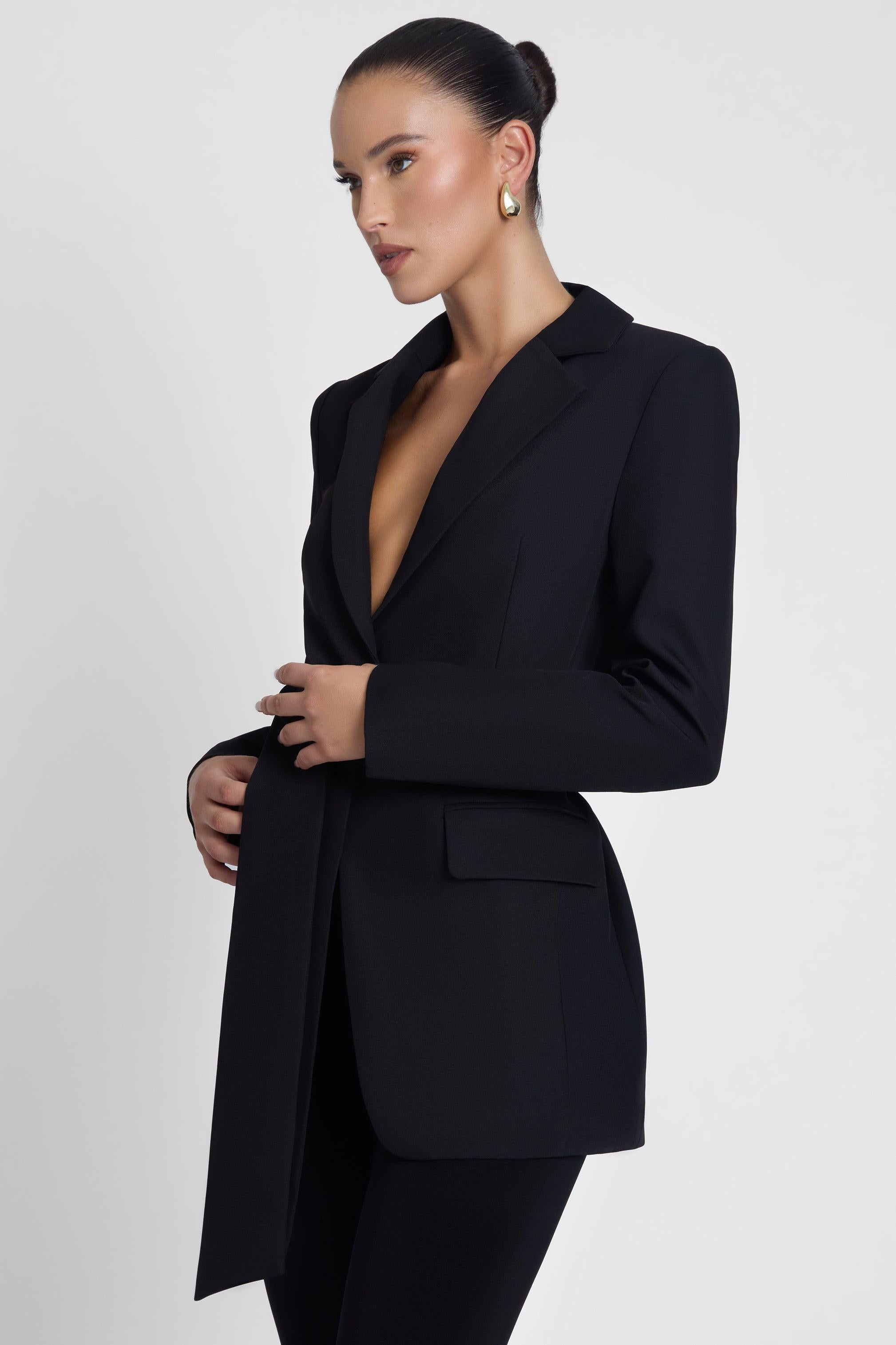 Model is wearing Classic Column Tailored Belted Blazer Black, side view.