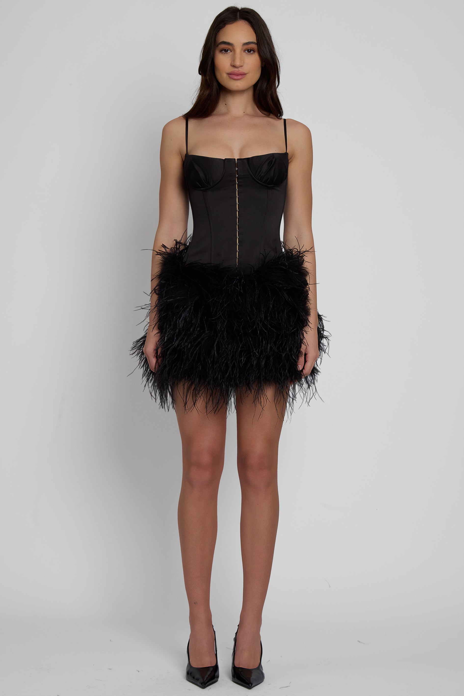 Model wearing Cloud Feather Mini Skirt in Black, front view.