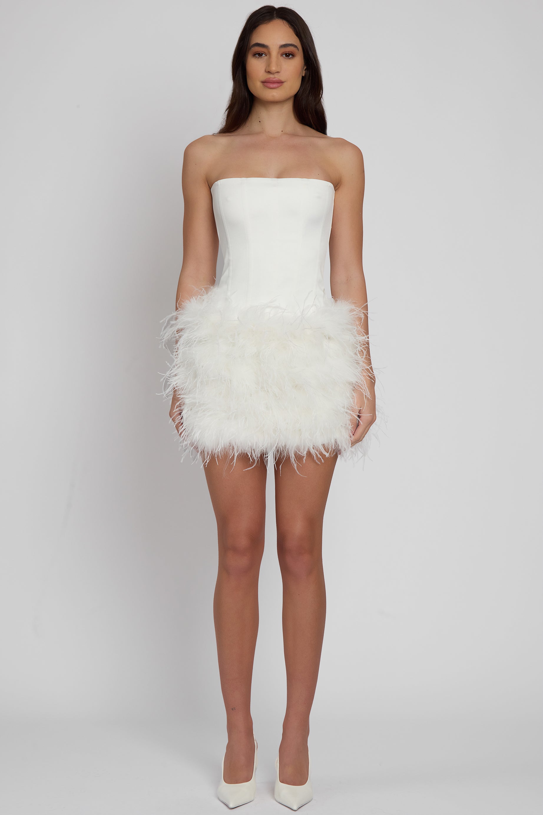 Model wearing Cloud Feather Mini Skirt in White, front view.
