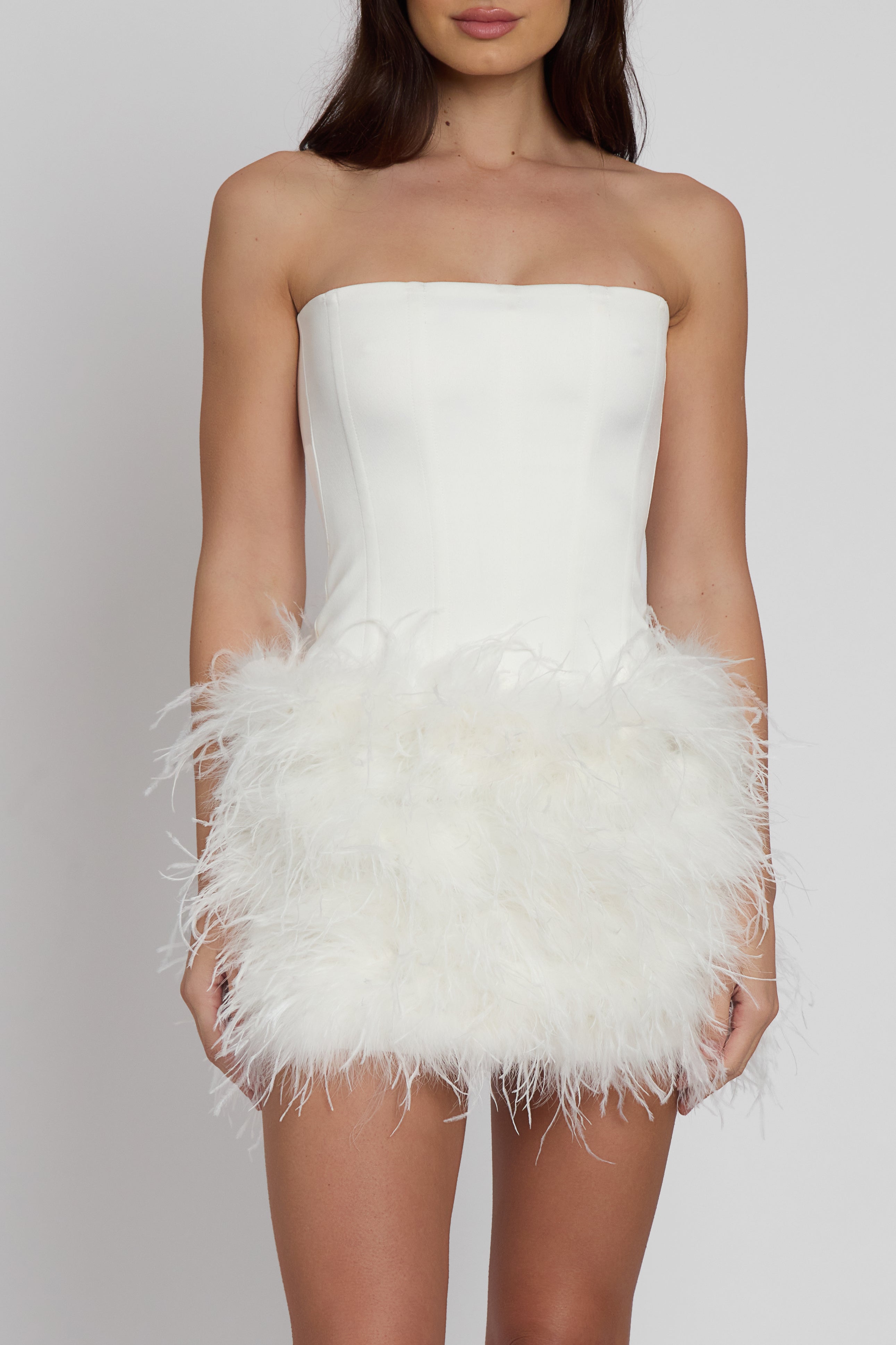 Model wearing Cloud Feather Mini Skirt in White, front view.