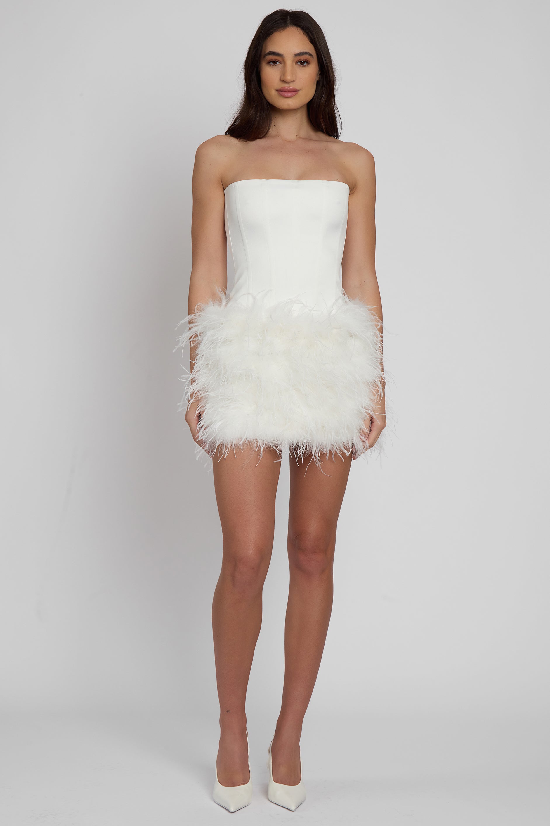 Model wearing Cloud Feather Mini Skirt in White, front view.