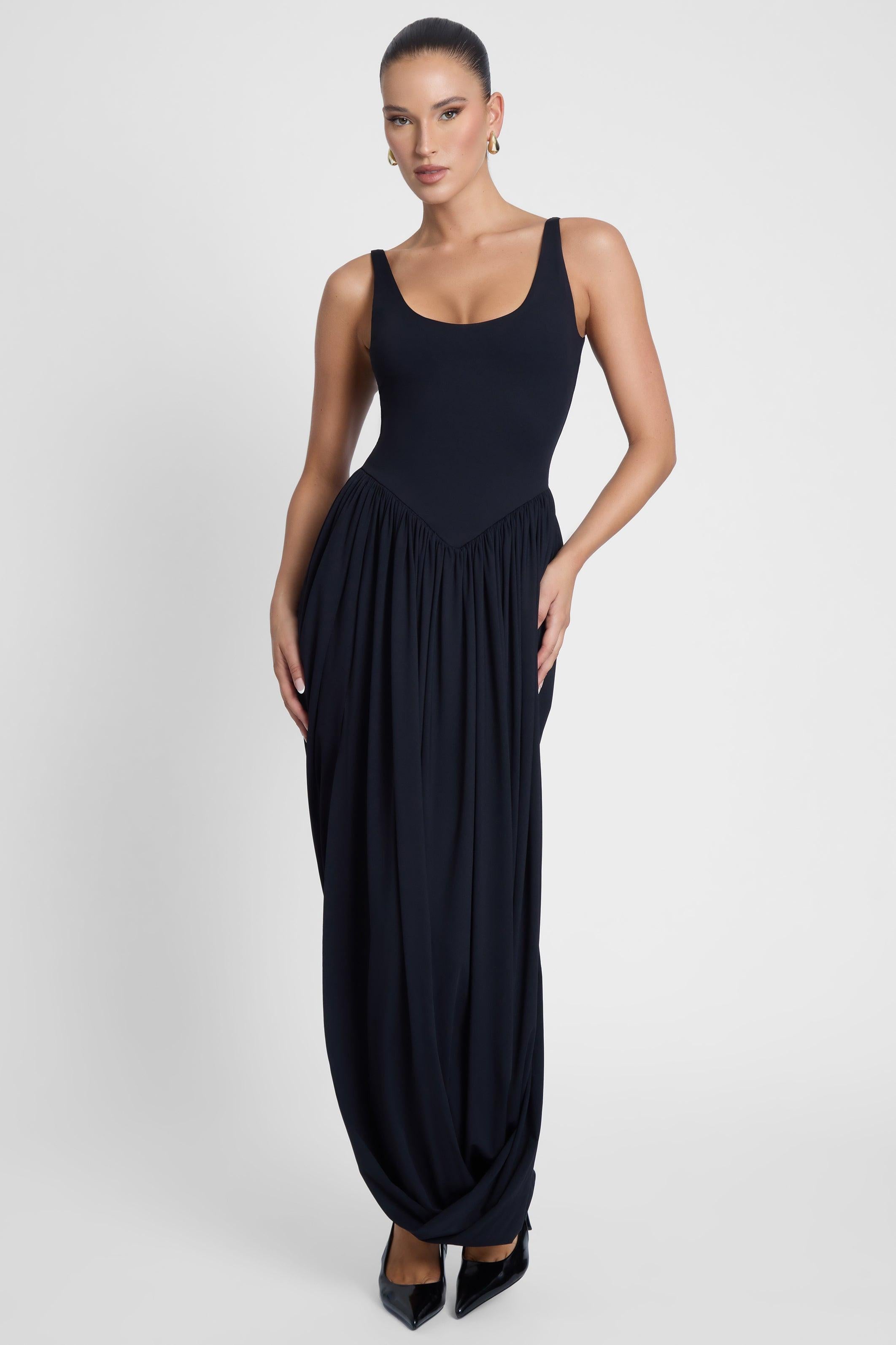 Model is wearing Dionysus Sculpt Drape Midi Dress, front view.