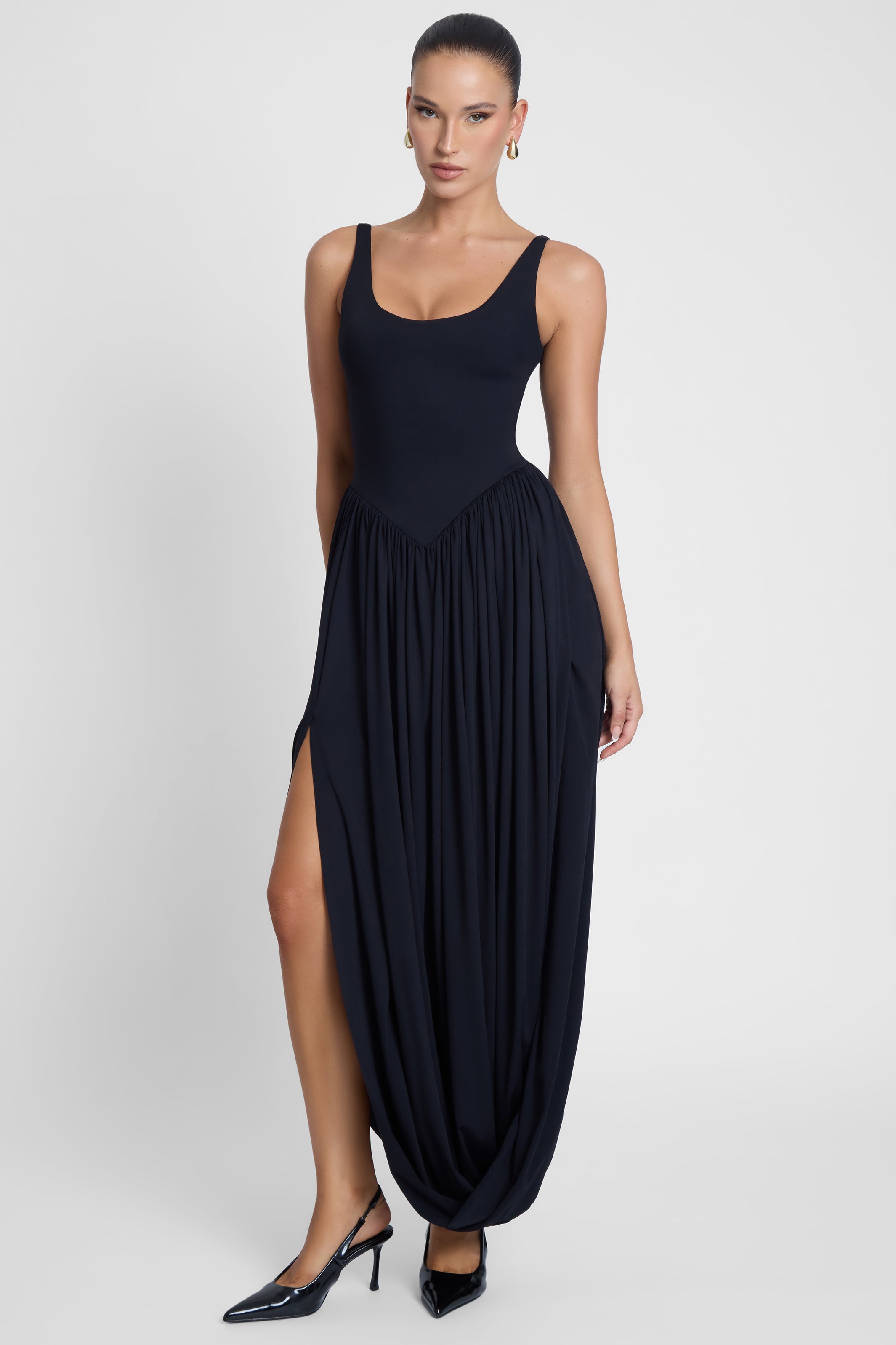 Model is wearing Dionysus Sculpt Drape Midi Dress, front view.