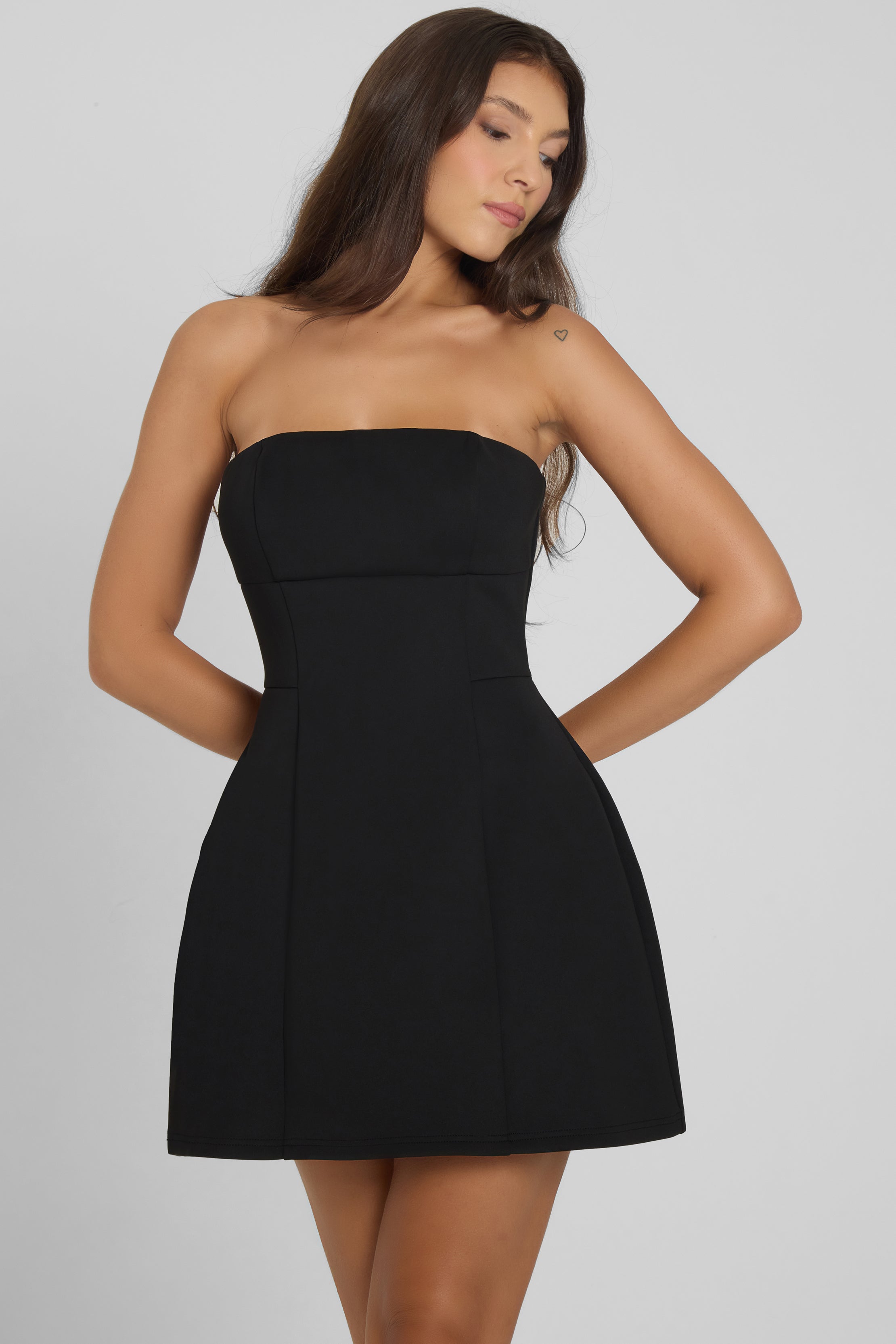 Model wearing Eres Strapless Bustier Mini Dress in Black, front view.