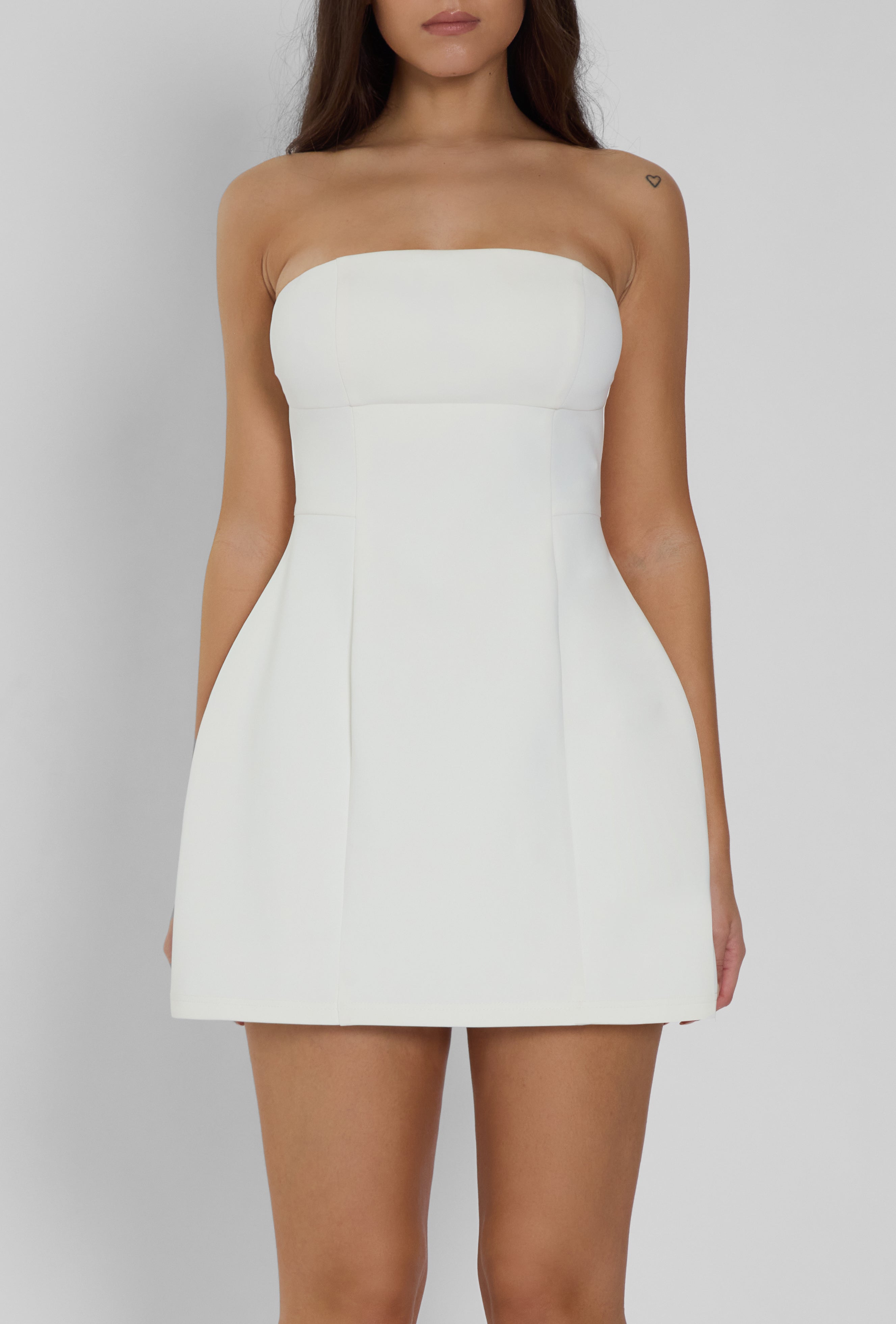 Model wearing Eres Strapless Bustier Mini Dress in White, front view.