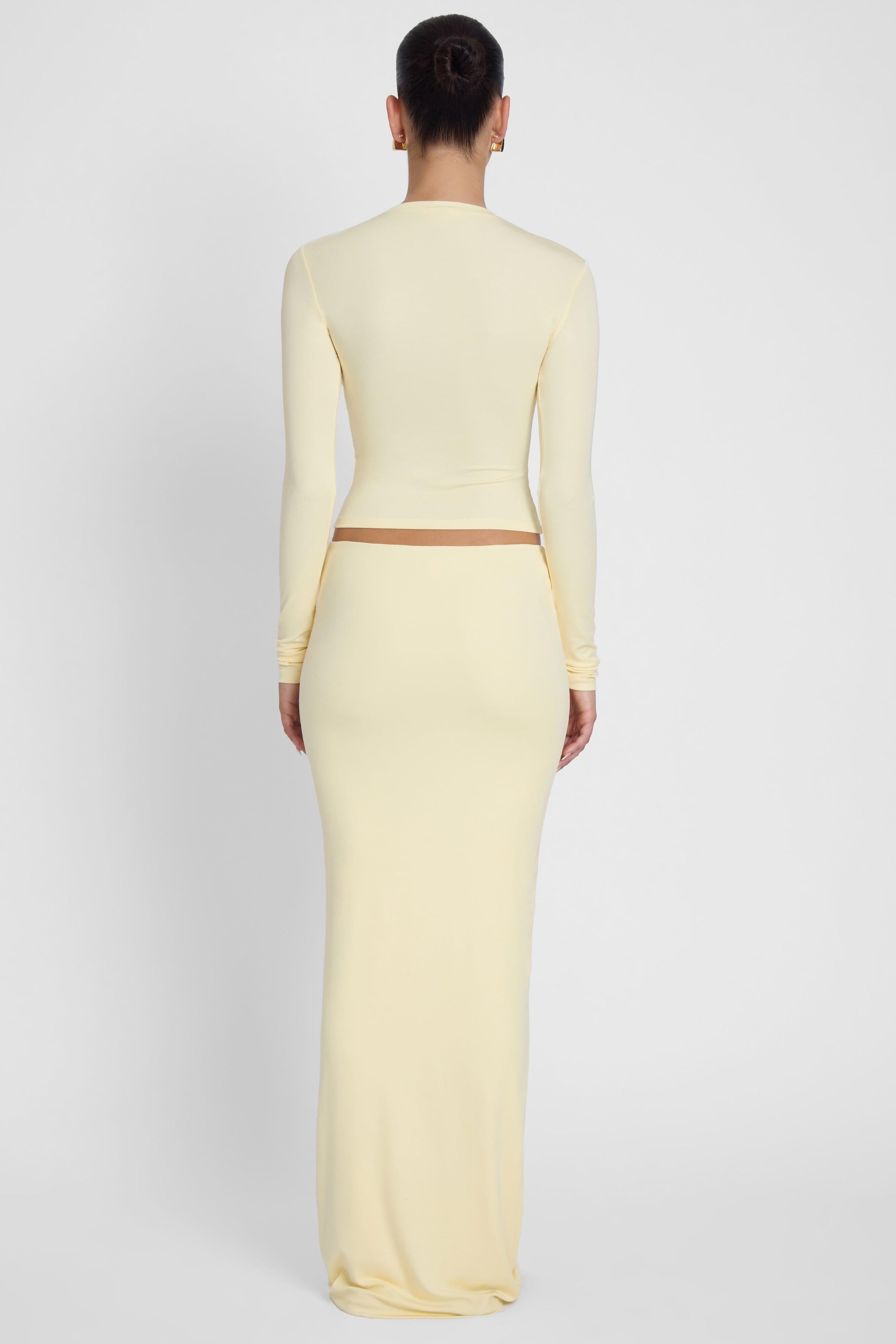 Model is wearing Everyday Jersey Long Sleeve Top Yellow, back view.