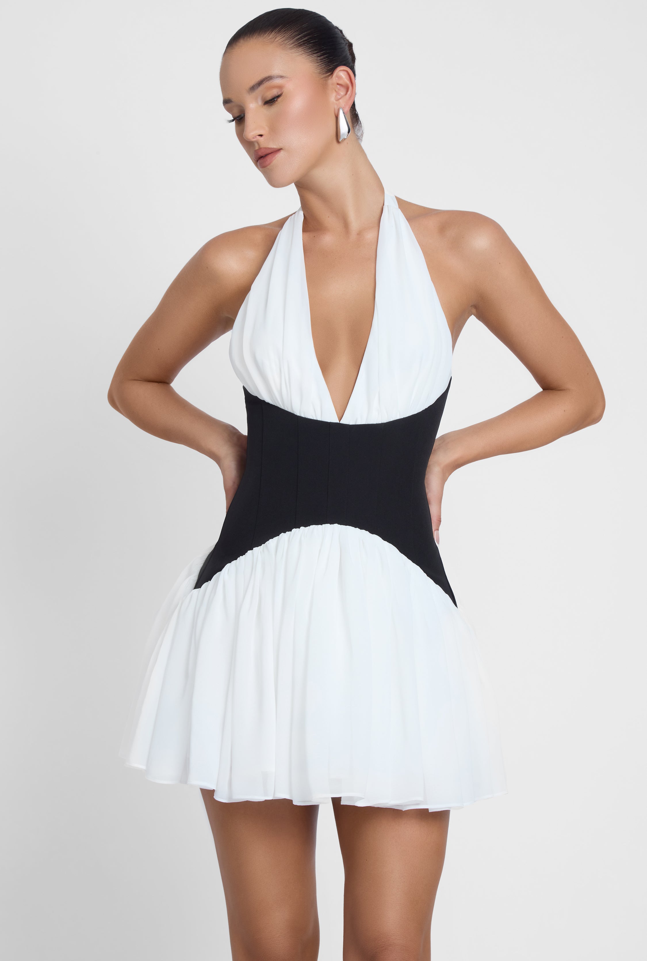 Model is wearing Harper Contrast Corset Mini Dress White, front view.