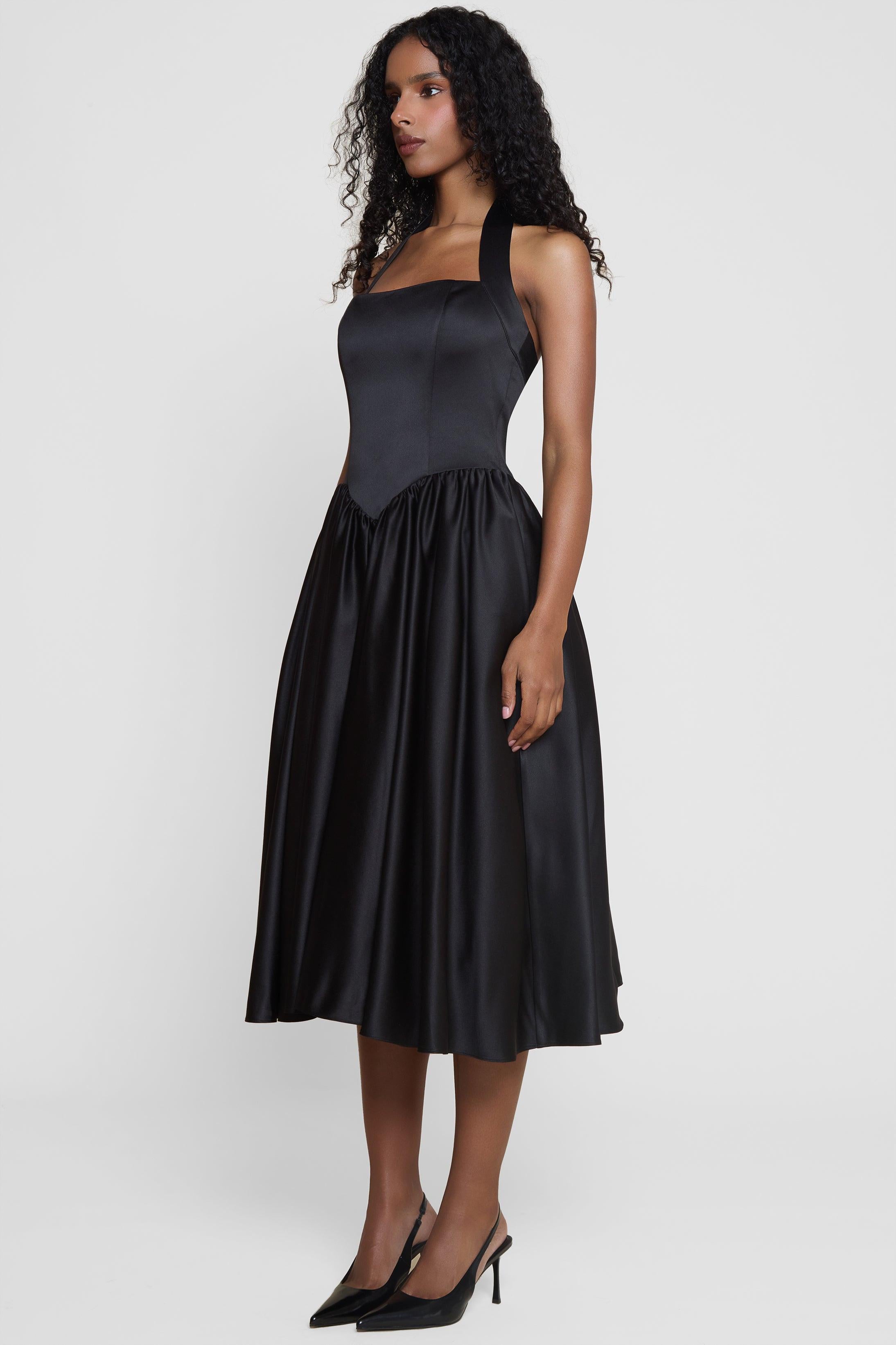 Model wearing Hart Halter Corset Midi Dress in Black, side view
