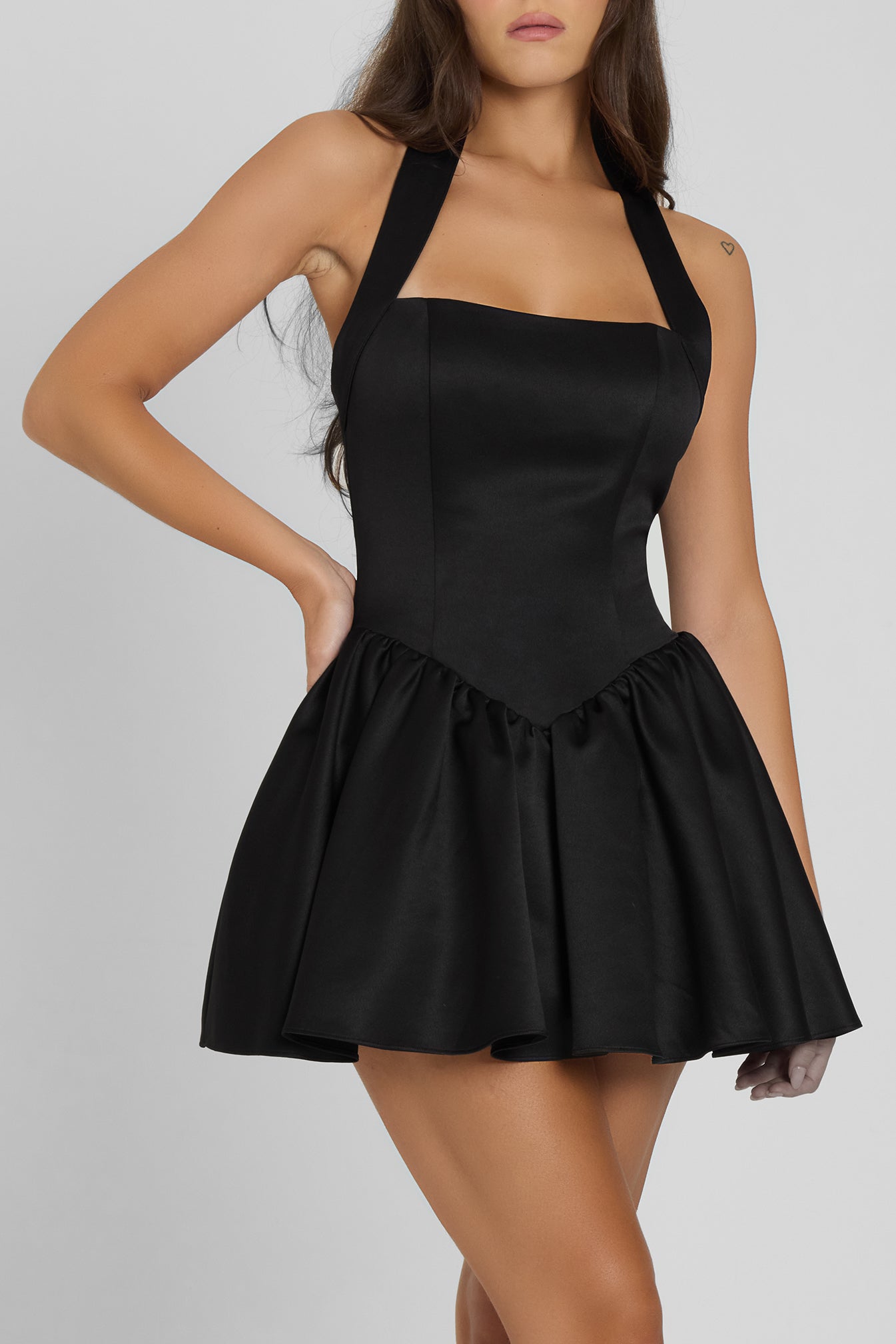 Model wearing Hyades Halter Corset Mini Dress in Black, front view.