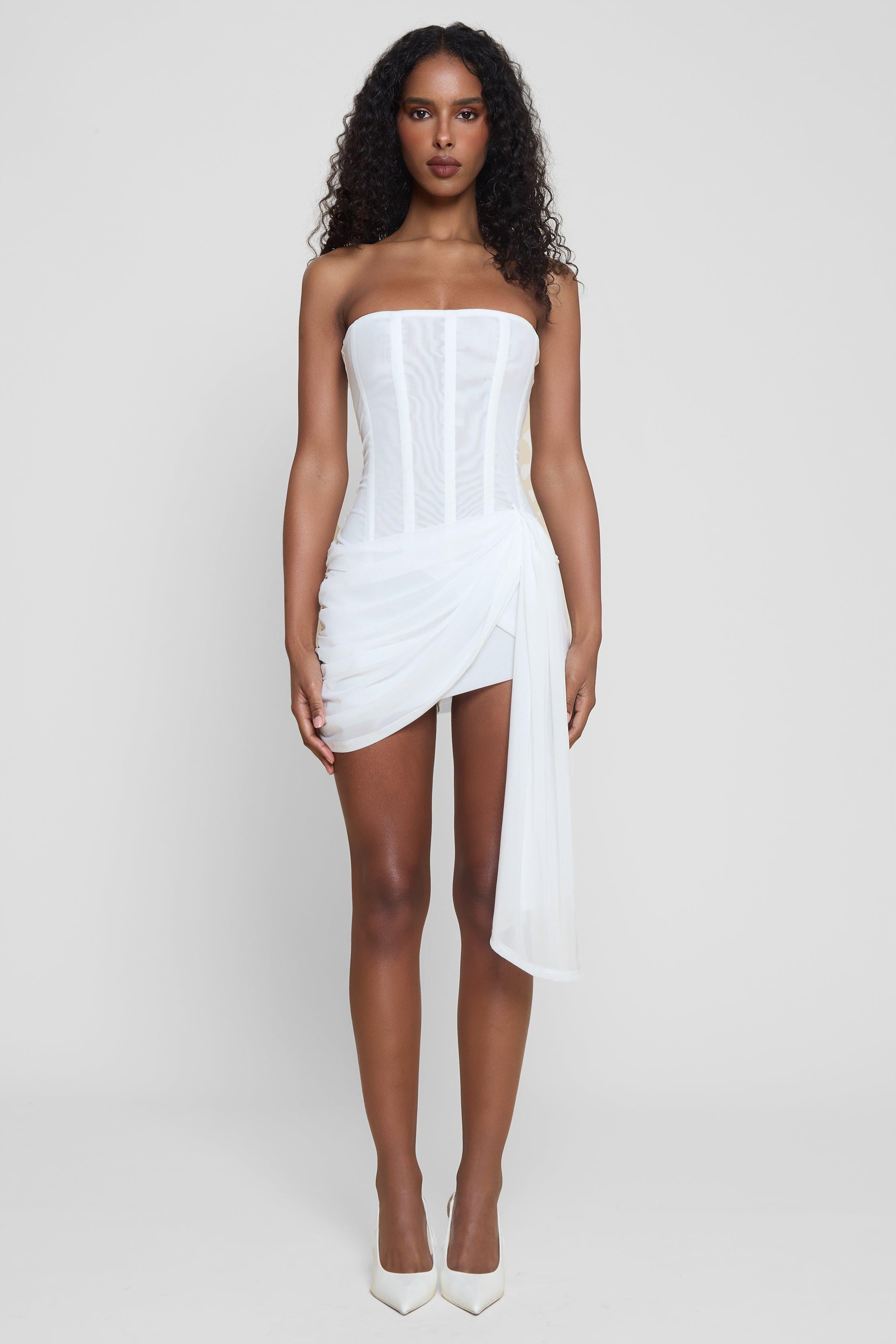 Model wearing Mira Mesh Corset Dress in White, front view.