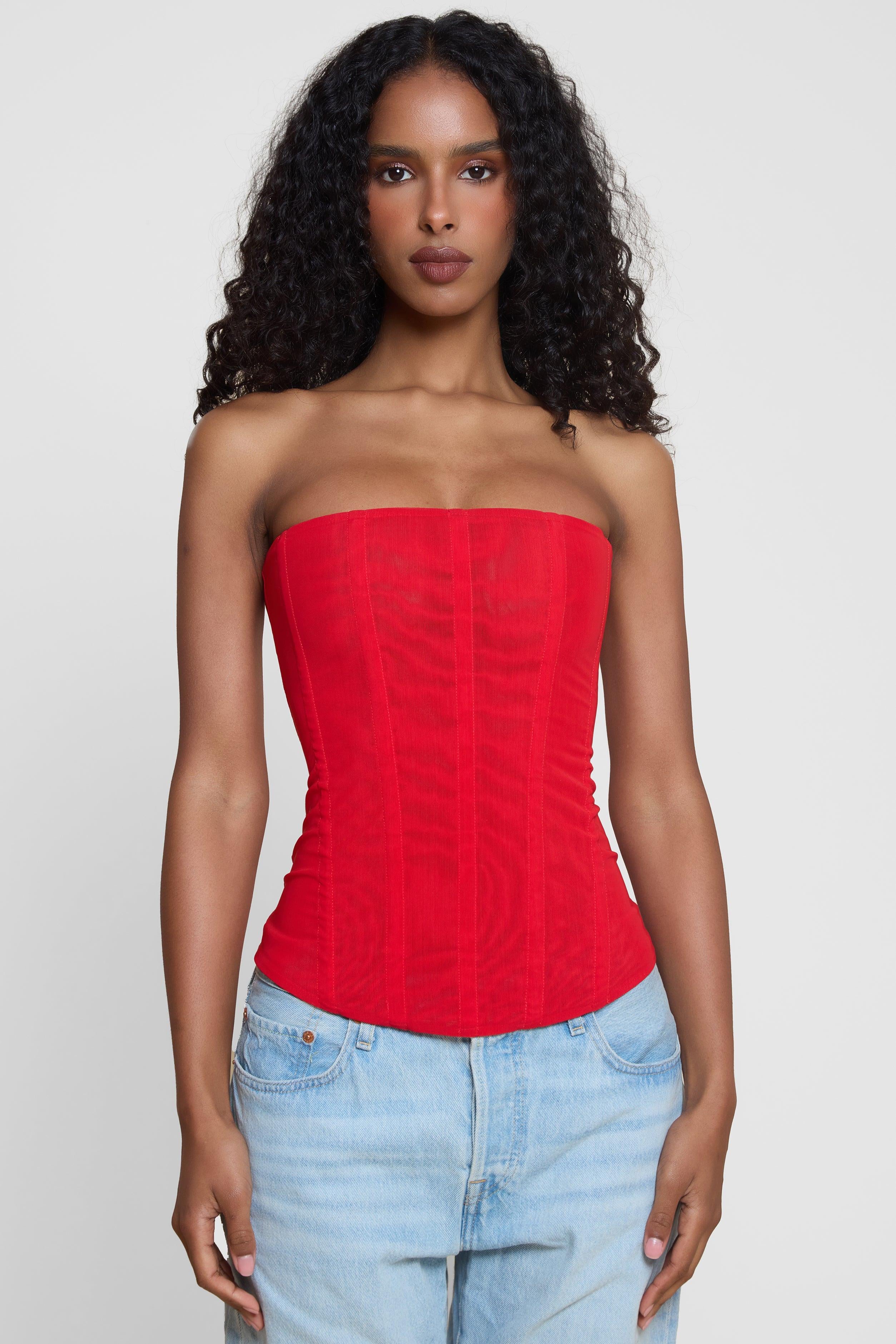 Model wearing Muse Mesh Corset Top in Red, front view.