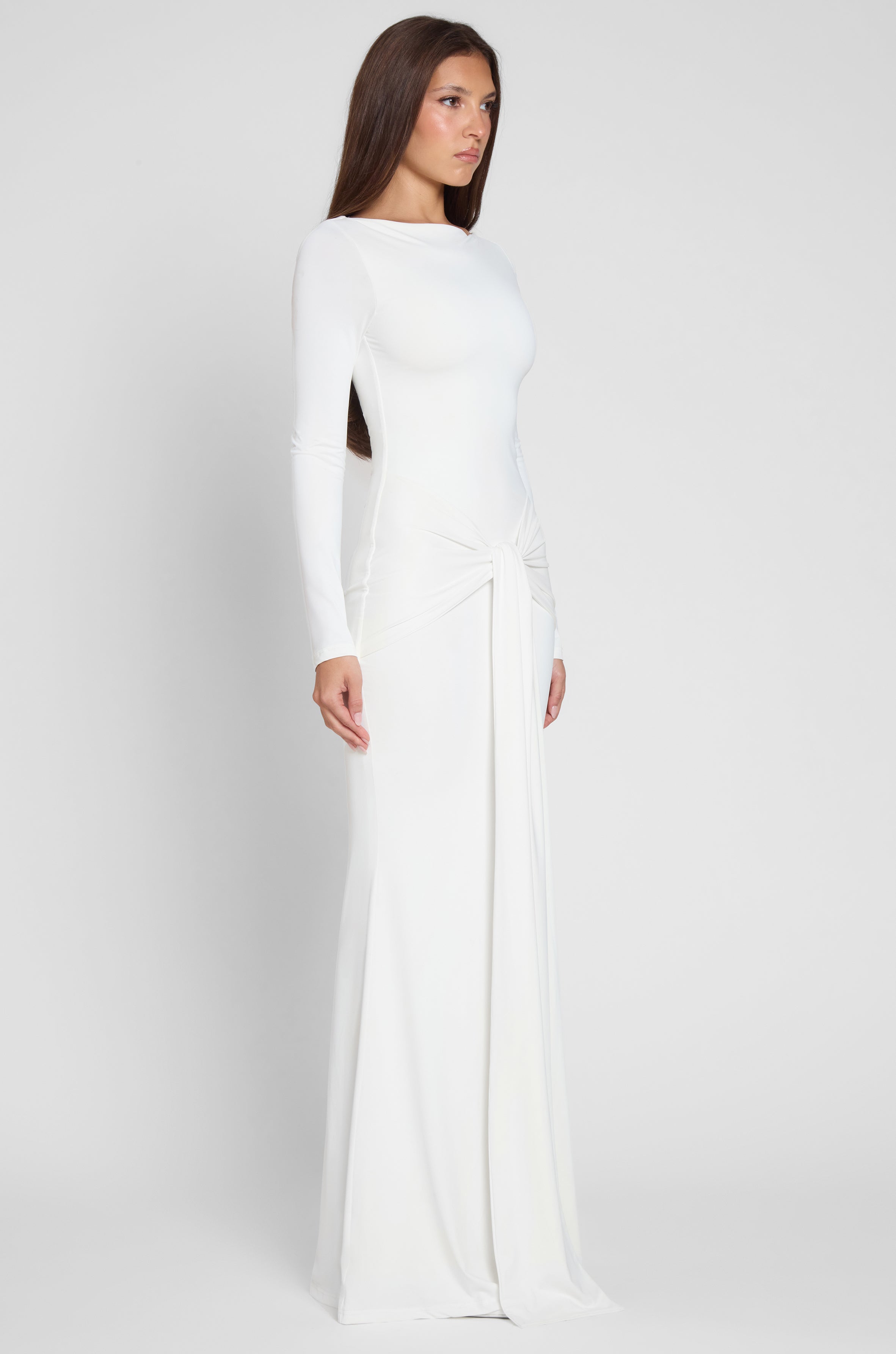 Model is wearing Oasis Knot Maxi Dress in White, side view.