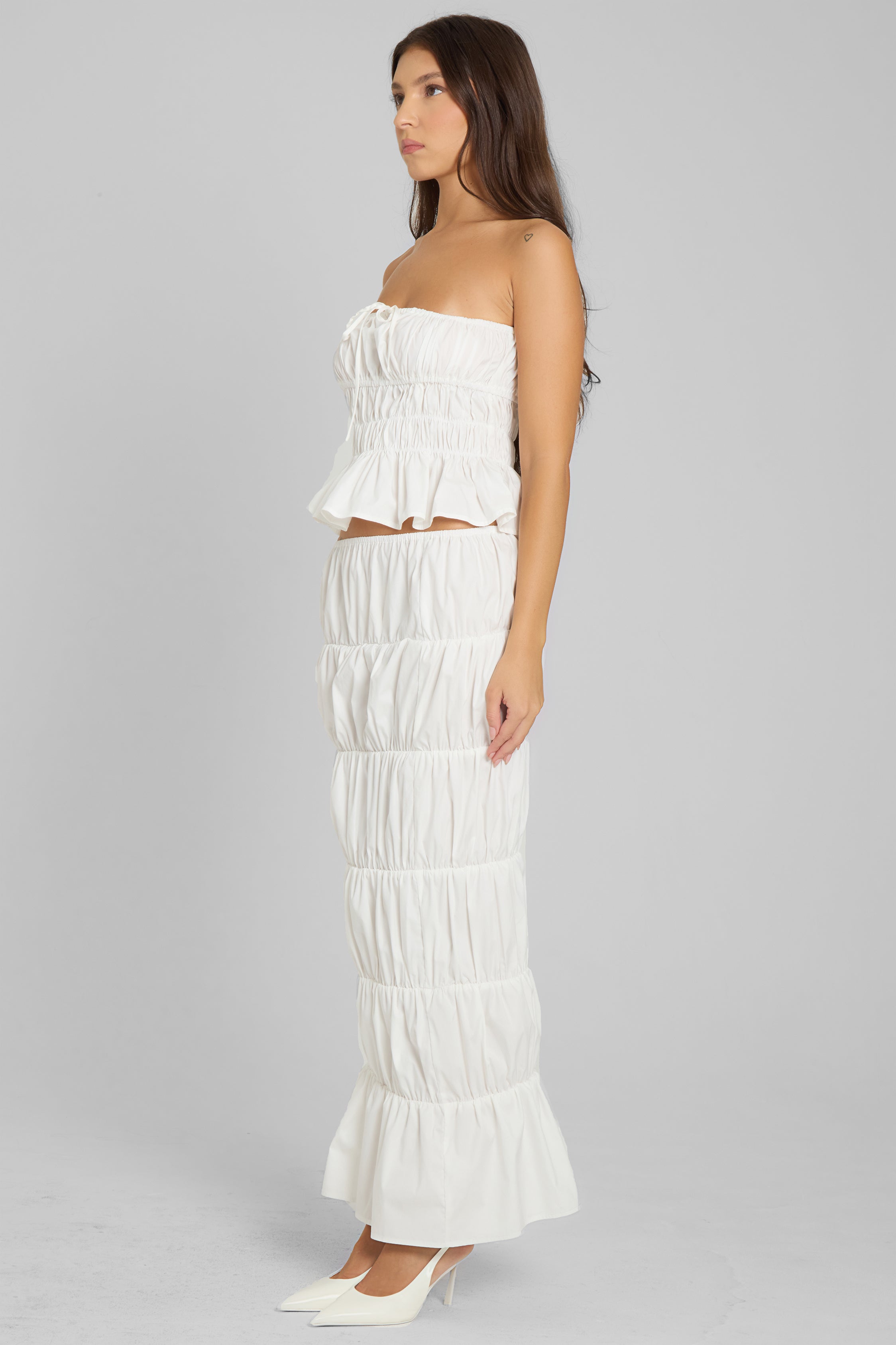 Model wearing LEAU Reverie Ruffle Two Piece Set in White, side view.