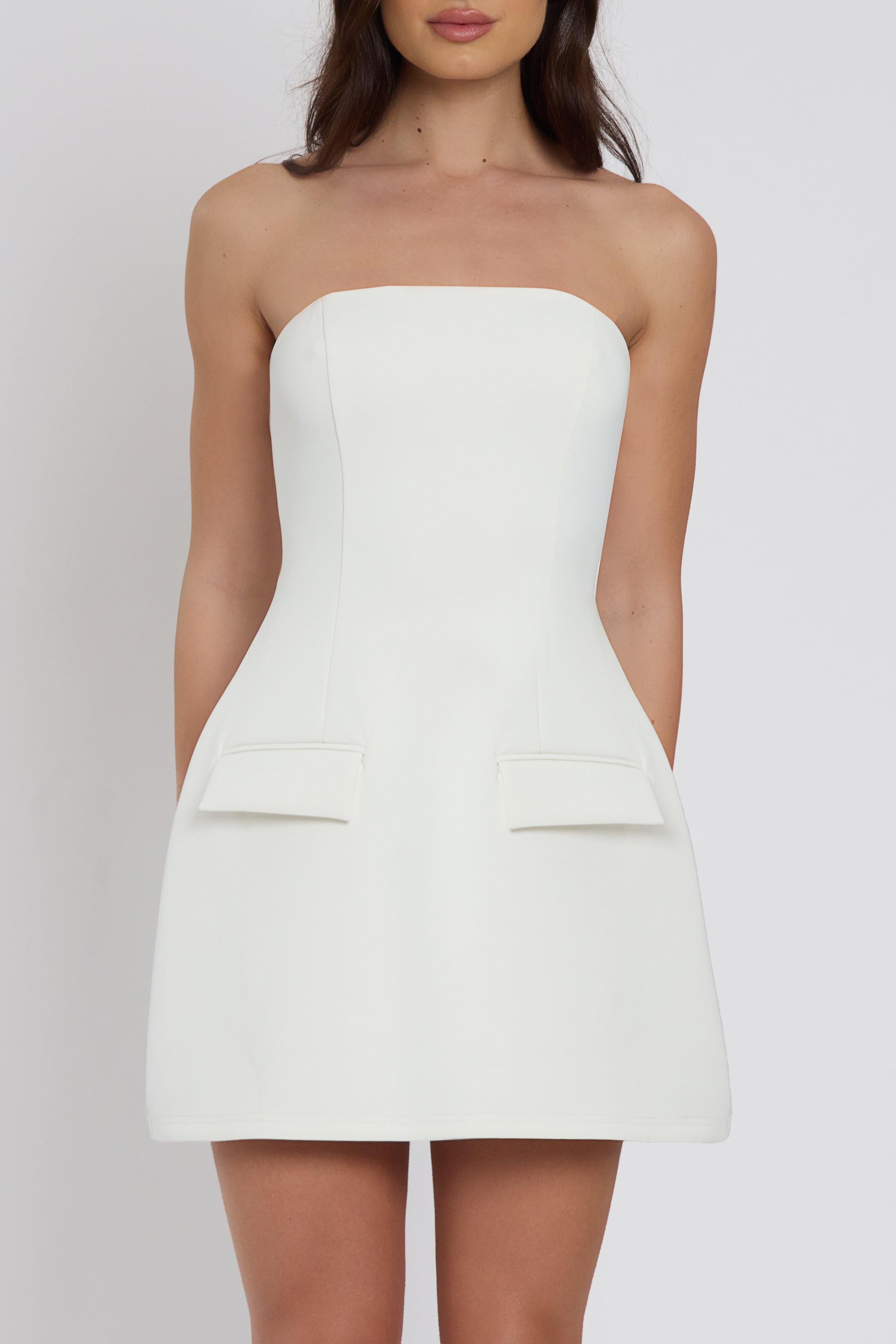 Model wearing Solene Strapless Pocket Mini Dress in White, front view.