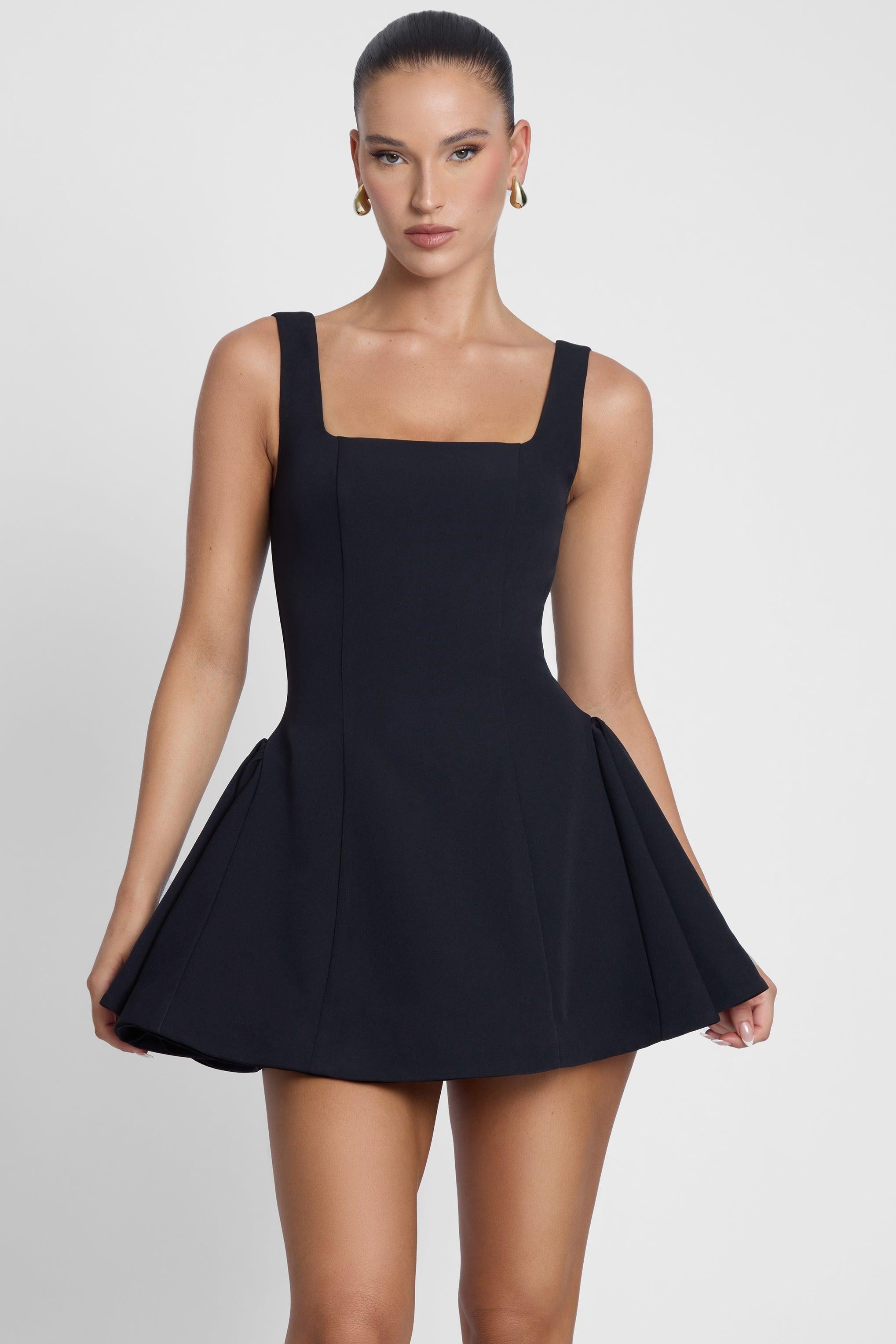 Model is wearing Ysabelle Babydoll Corset Mini Dress Black, front view.