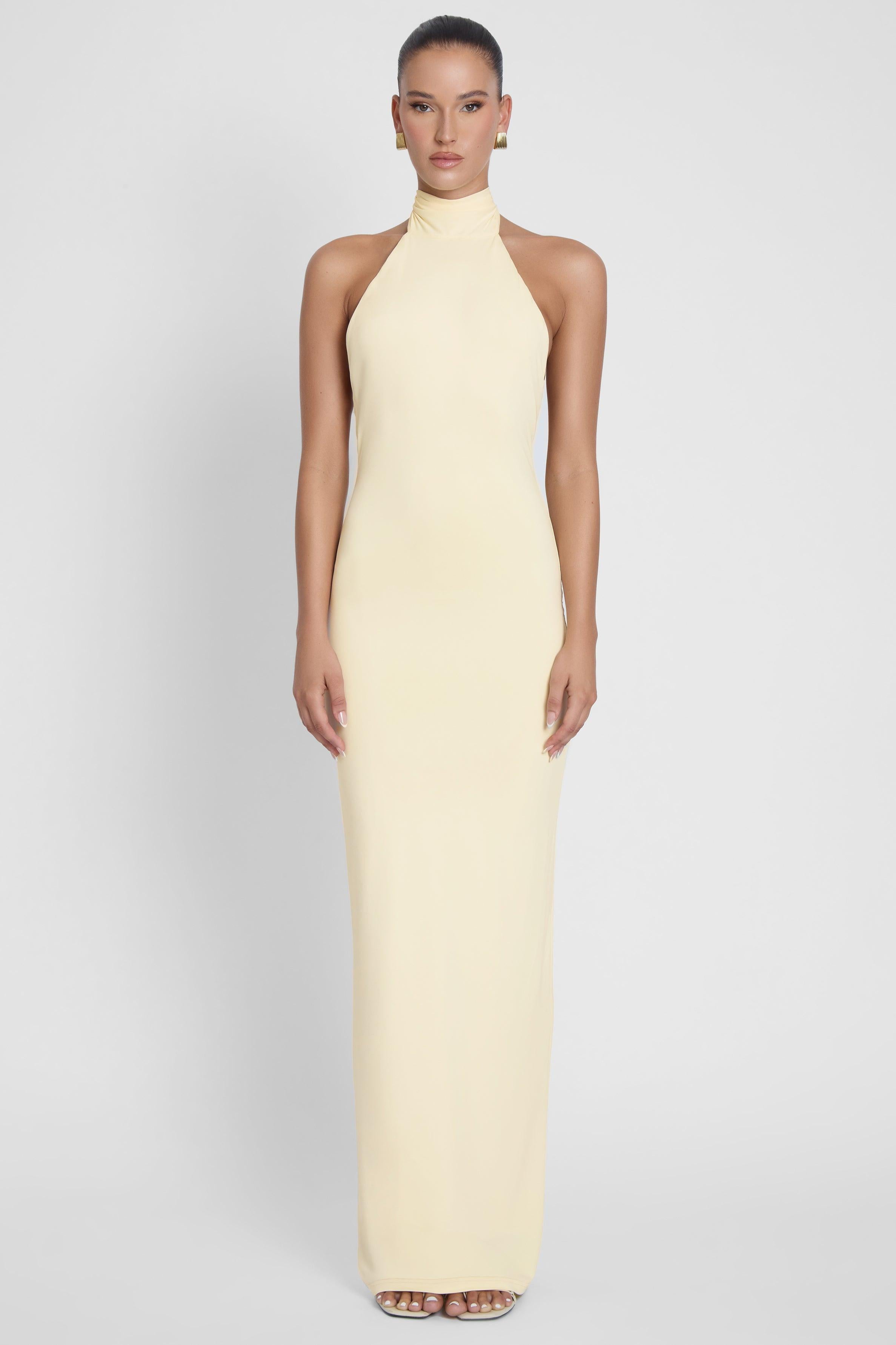 Model is wearing Alaia Drape Maxi Dress Yellow, front view.