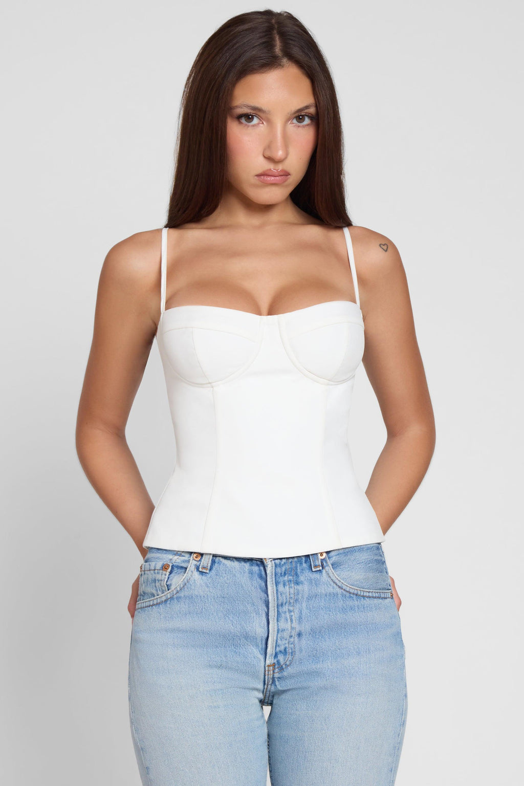 Model is wearing Bali Bustier Corset Top White, front view.