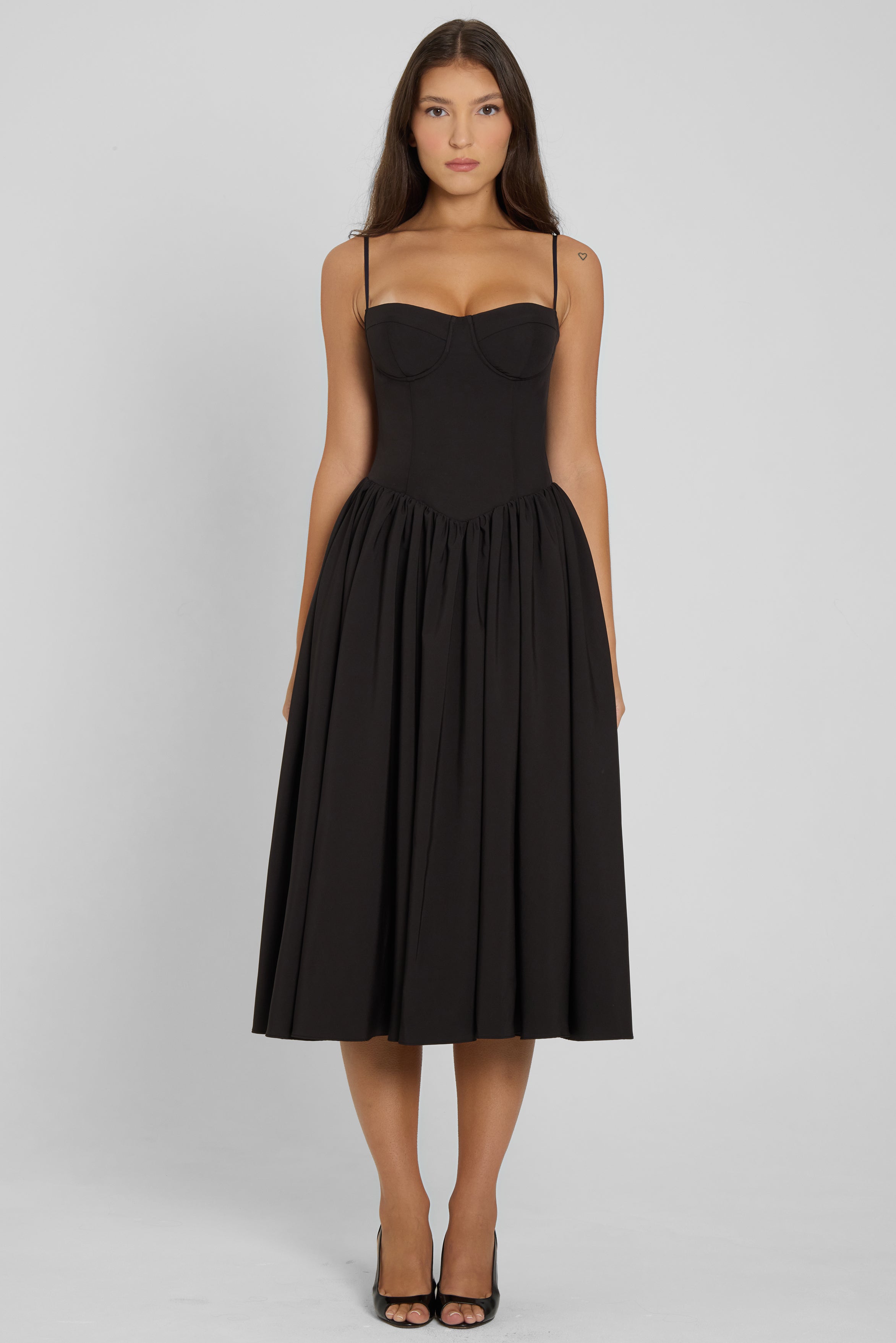 Model wearing Ballerina Bustier Midi Dress in Black, front view.