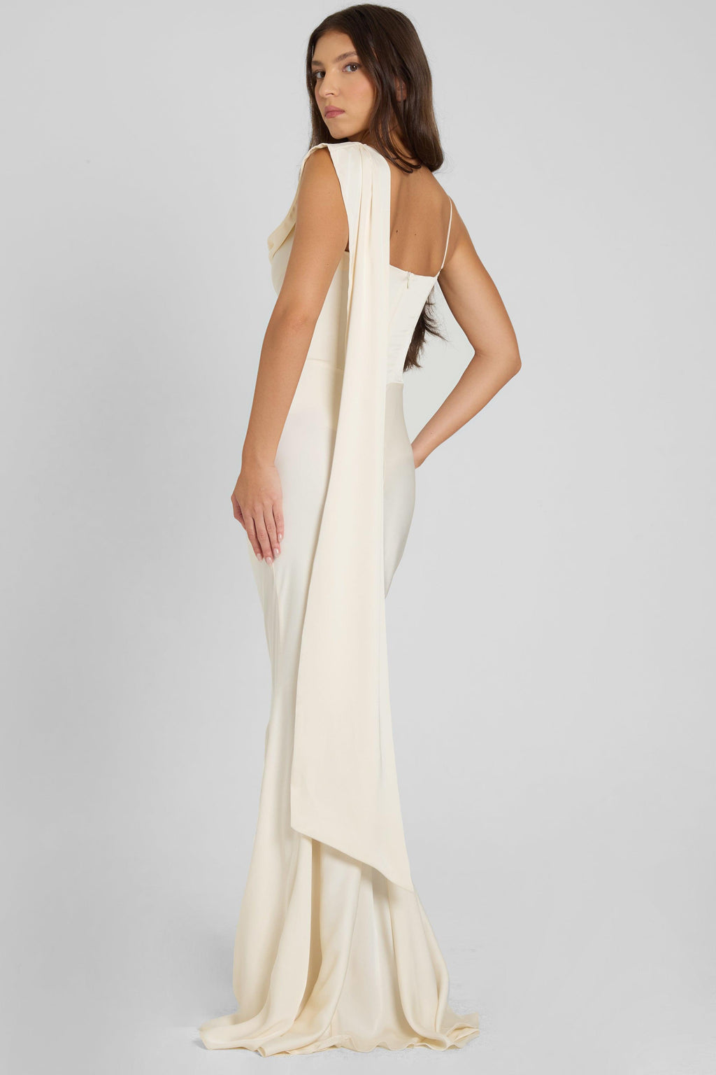 Model is wearing Celine Corset Drape Satin Gown in Ivory, back view.