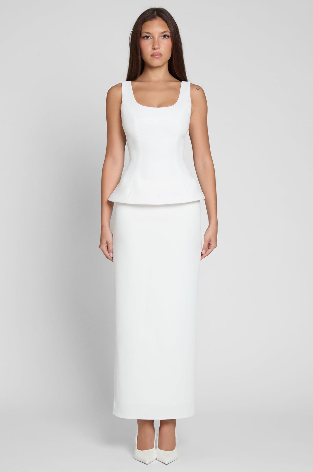 Model is wearing Classic Column Maxi Skirt in White, front view.