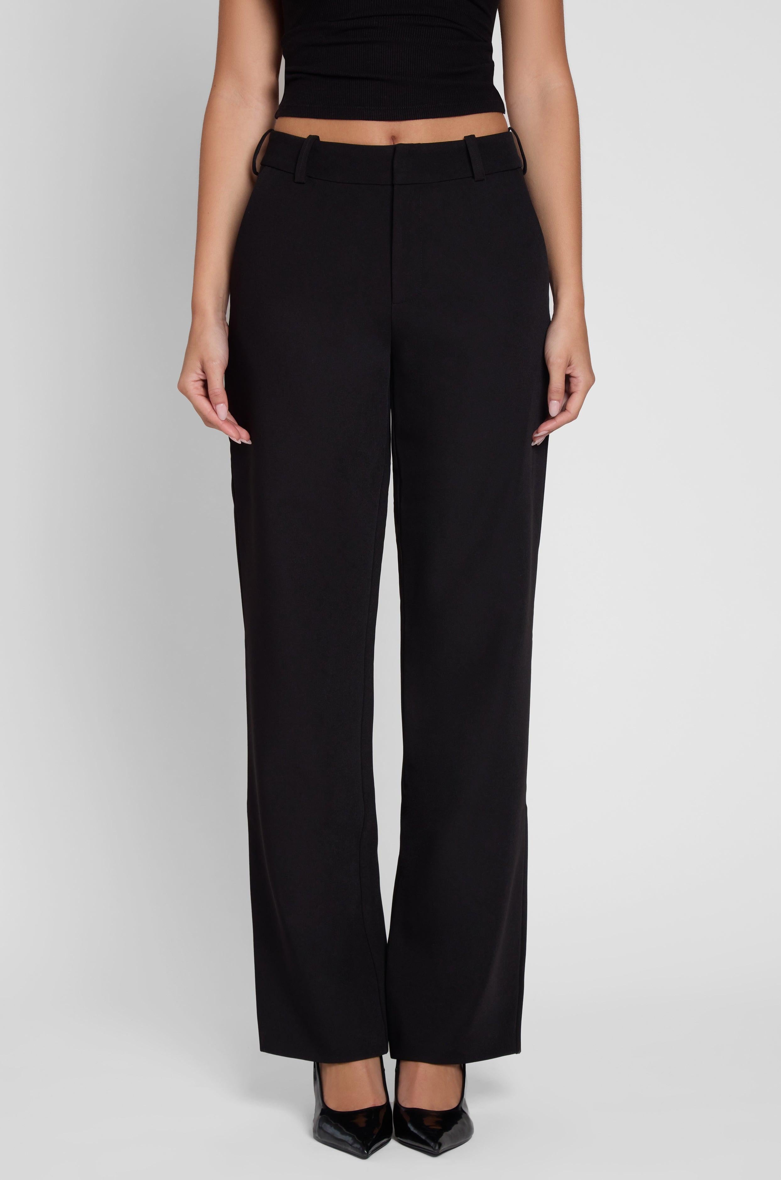 Model is wearing Classic Column Straight Trousers in Black, front view.