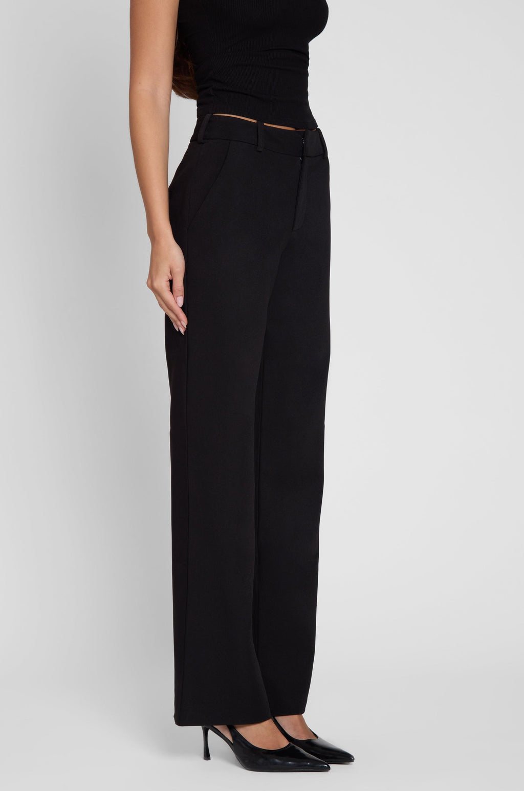 Model is wearing Classic Column Straight Trousers in Black, side view.