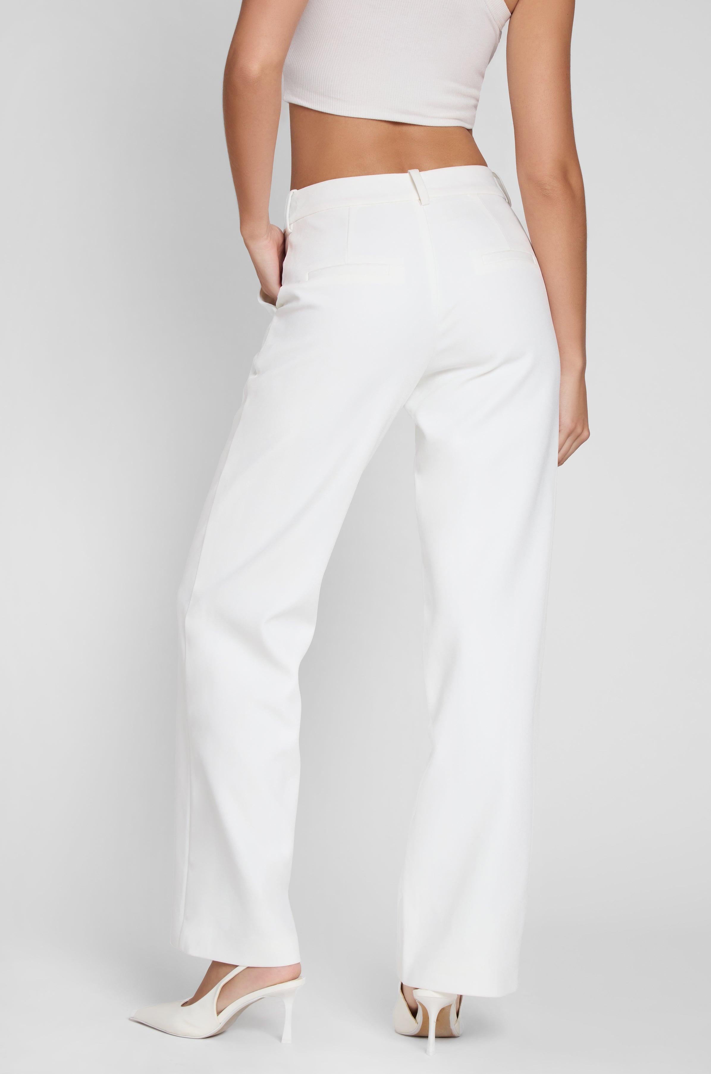Model wearing Classic Column Straight Trousers in White, back view.