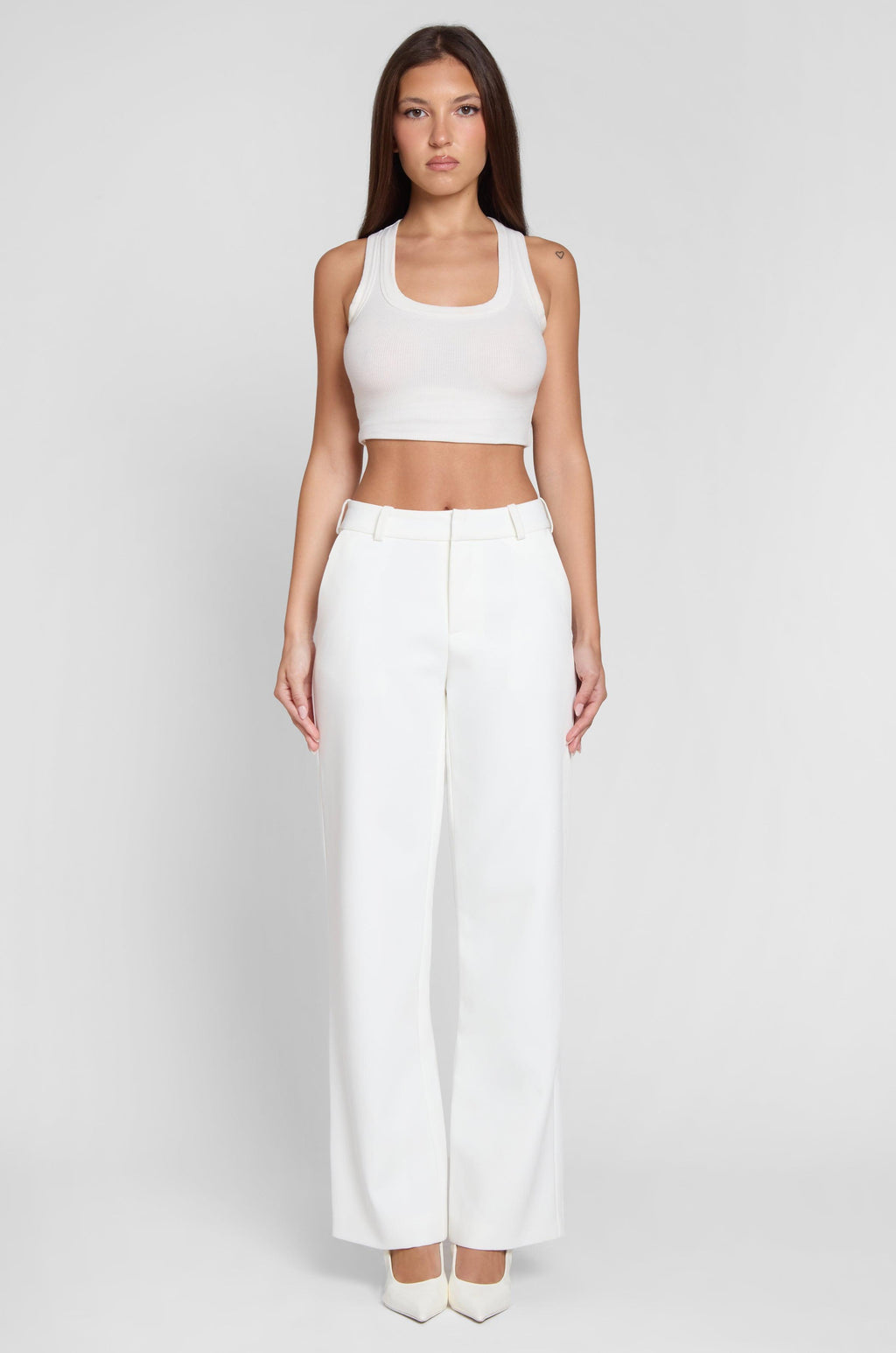 Model wearing Classic Column Straight Trousers in White, front view.