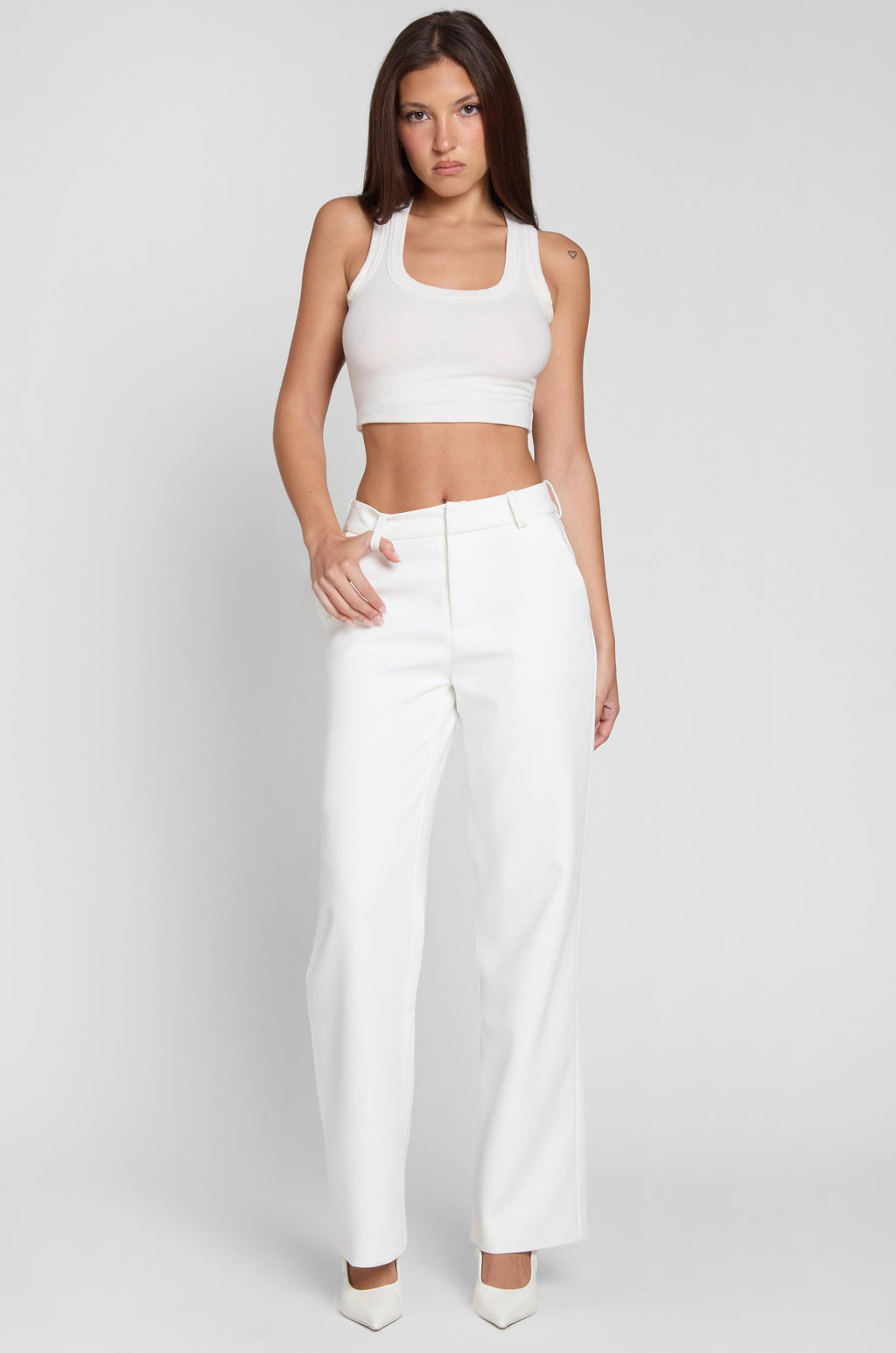 Model wearing Classic Column Straight Trousers in White, front view.