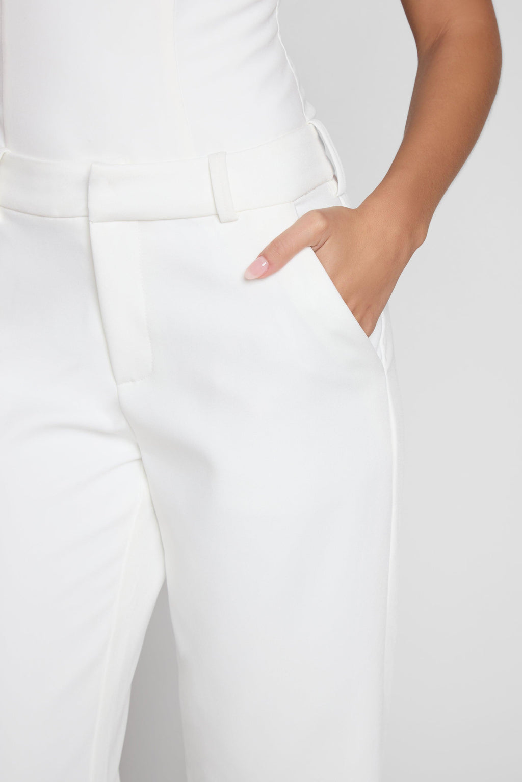 Model wearing Classic Column Straight Trousers in White, front view.