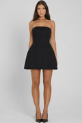 Model wearing Eres Strapless Bustier Mini Dress in Black, front view.