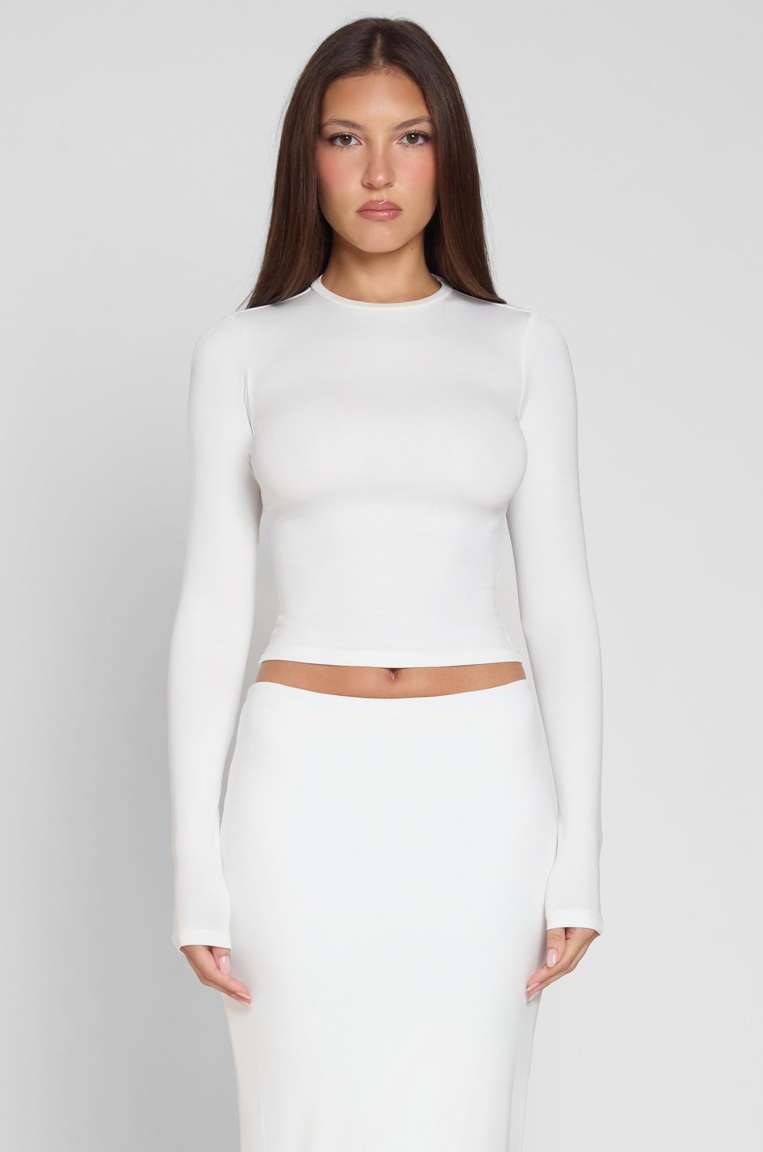 Model is wearing Everyday Jersey Long Sleeve Top in White, front view.