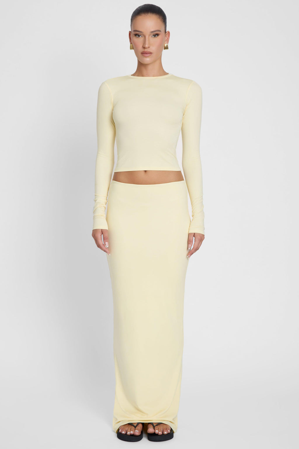 Model is wearing Everyday Jersey Maxi Skirt Yellow, front view.
