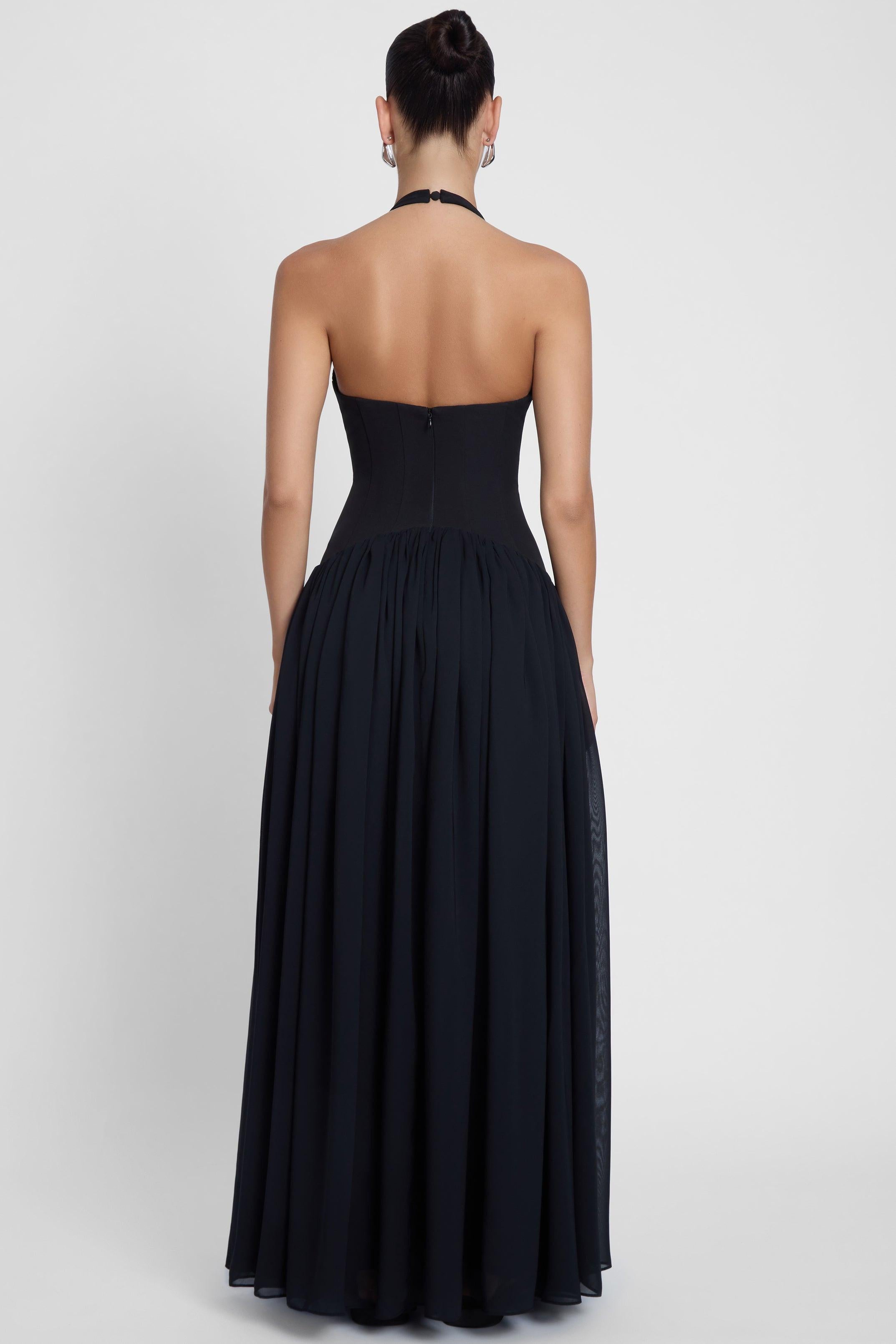 Model is wearing Harlowe Corset Maxi Dress Black, front view.