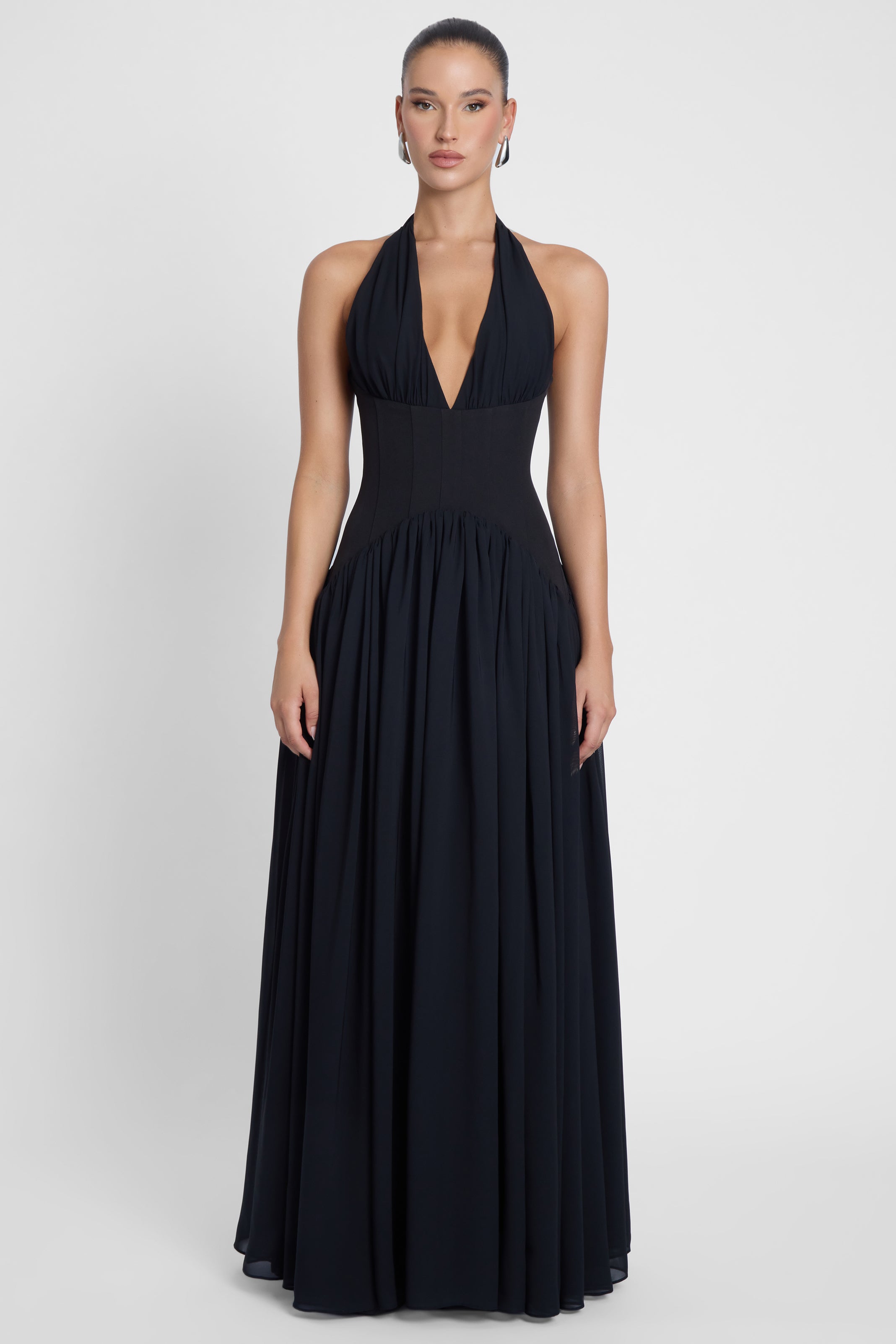 Model is wearing Harlowe Corset Maxi Dress Black, front view.