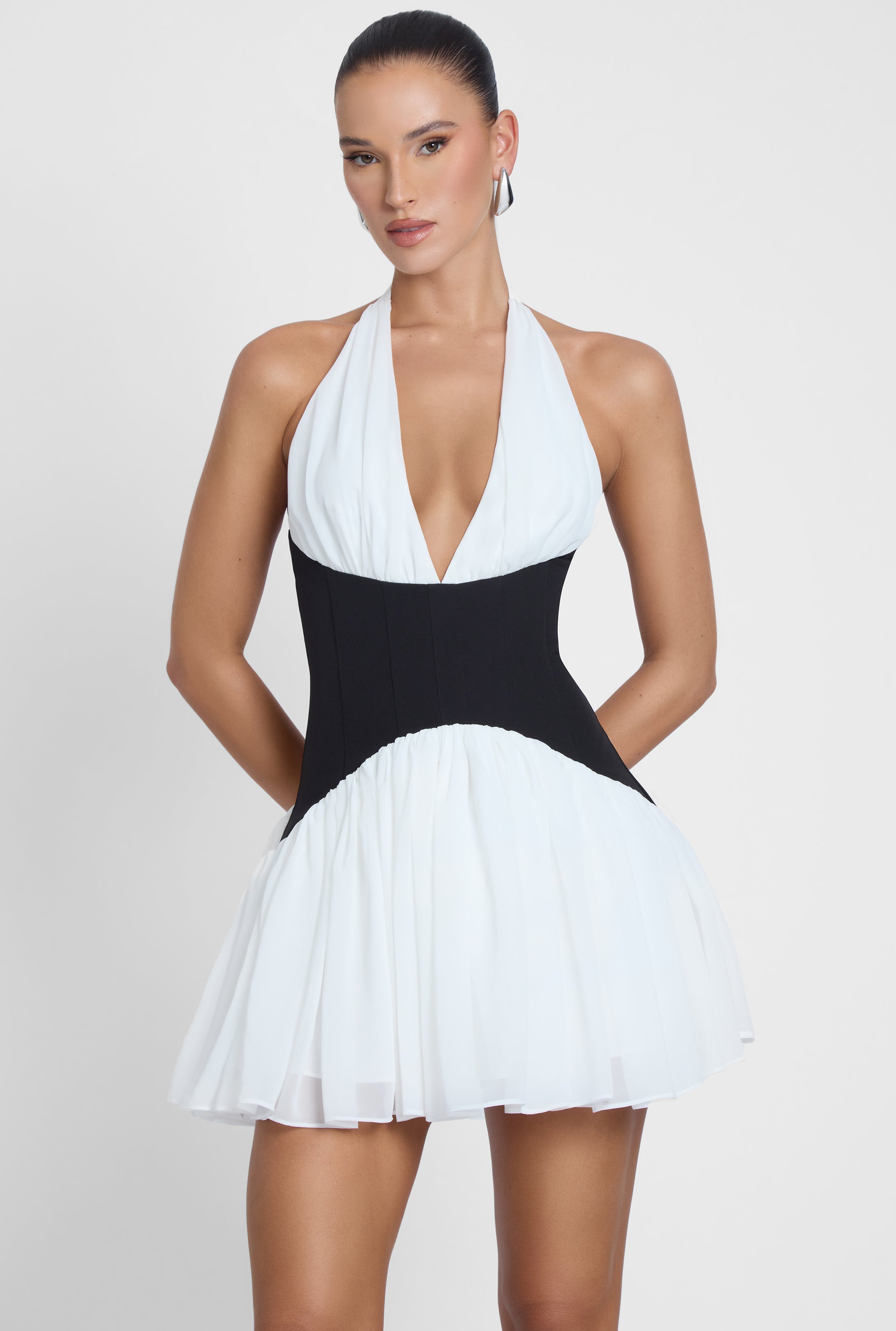 Model is wearing Harper Contrast Corset Mini Dress White, front view.