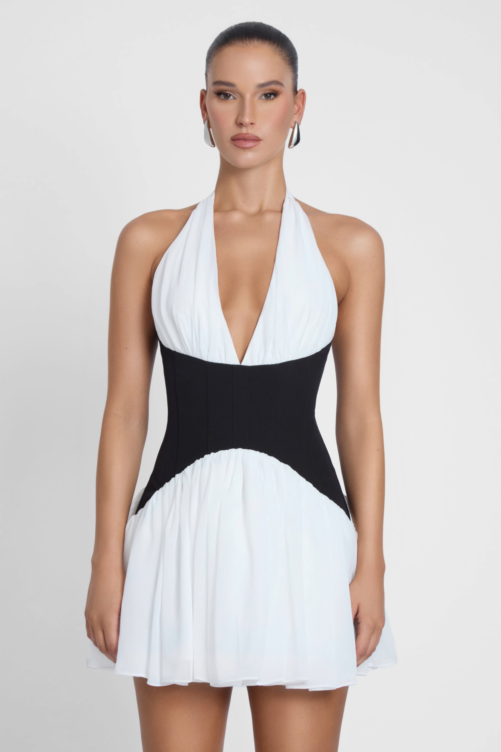 Model is wearing Harper Contrast Corset Mini Dress White, front view.